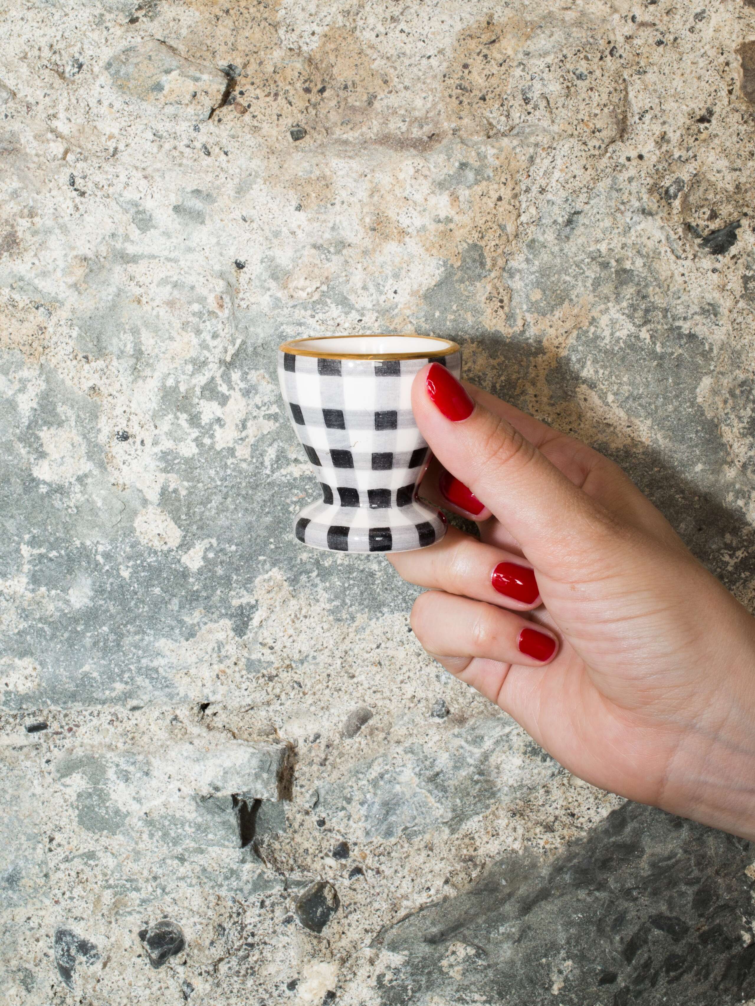 person holding egg cup 