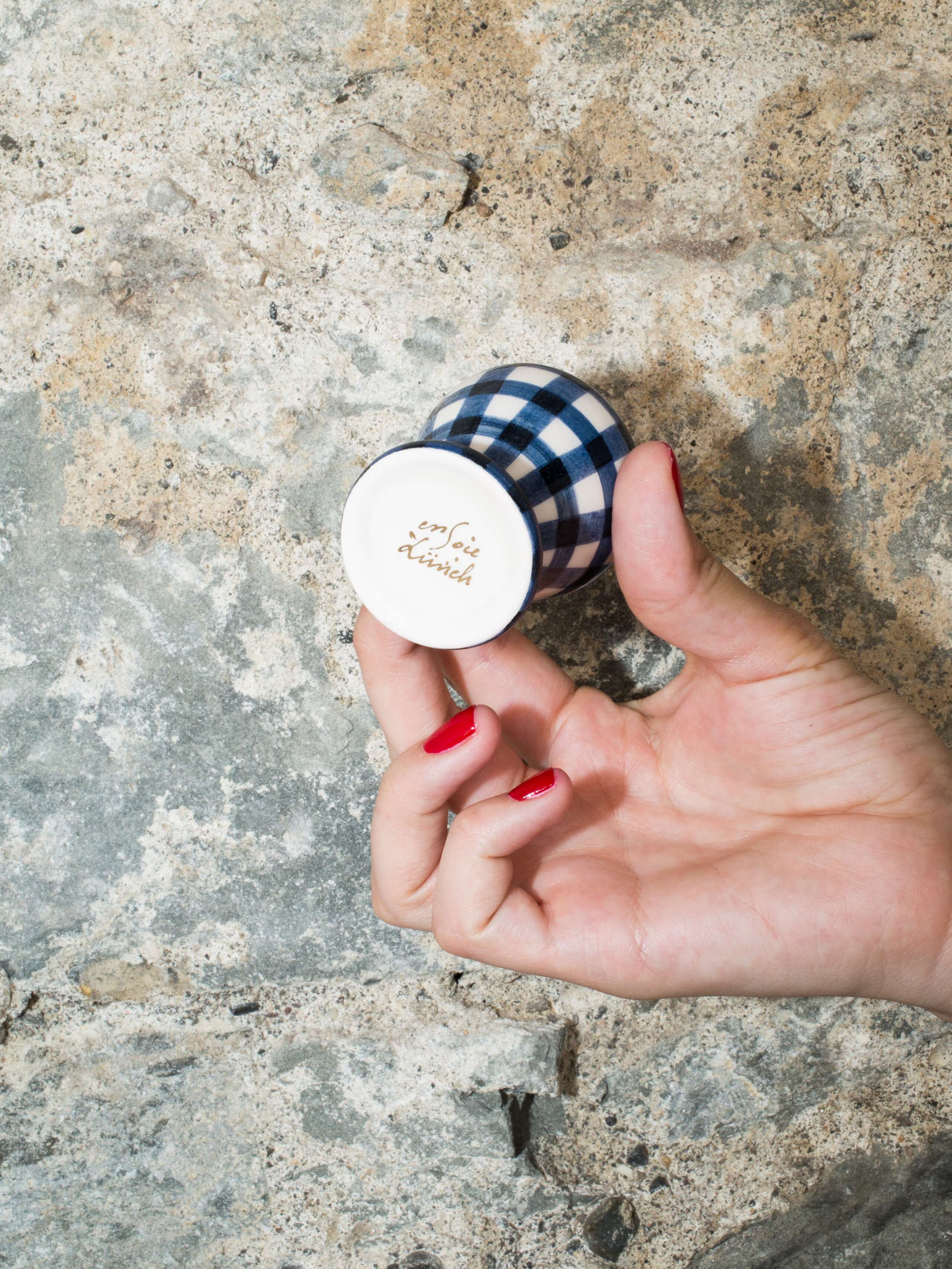person holding egg cup 