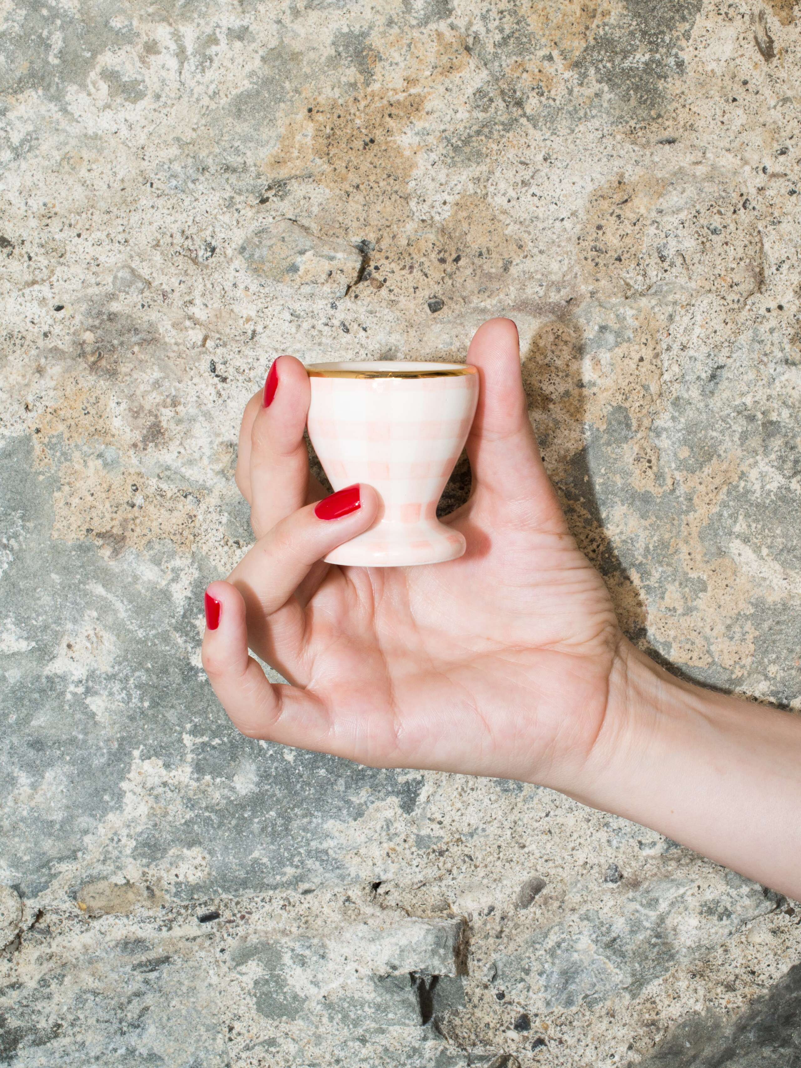 person holding egg cup 