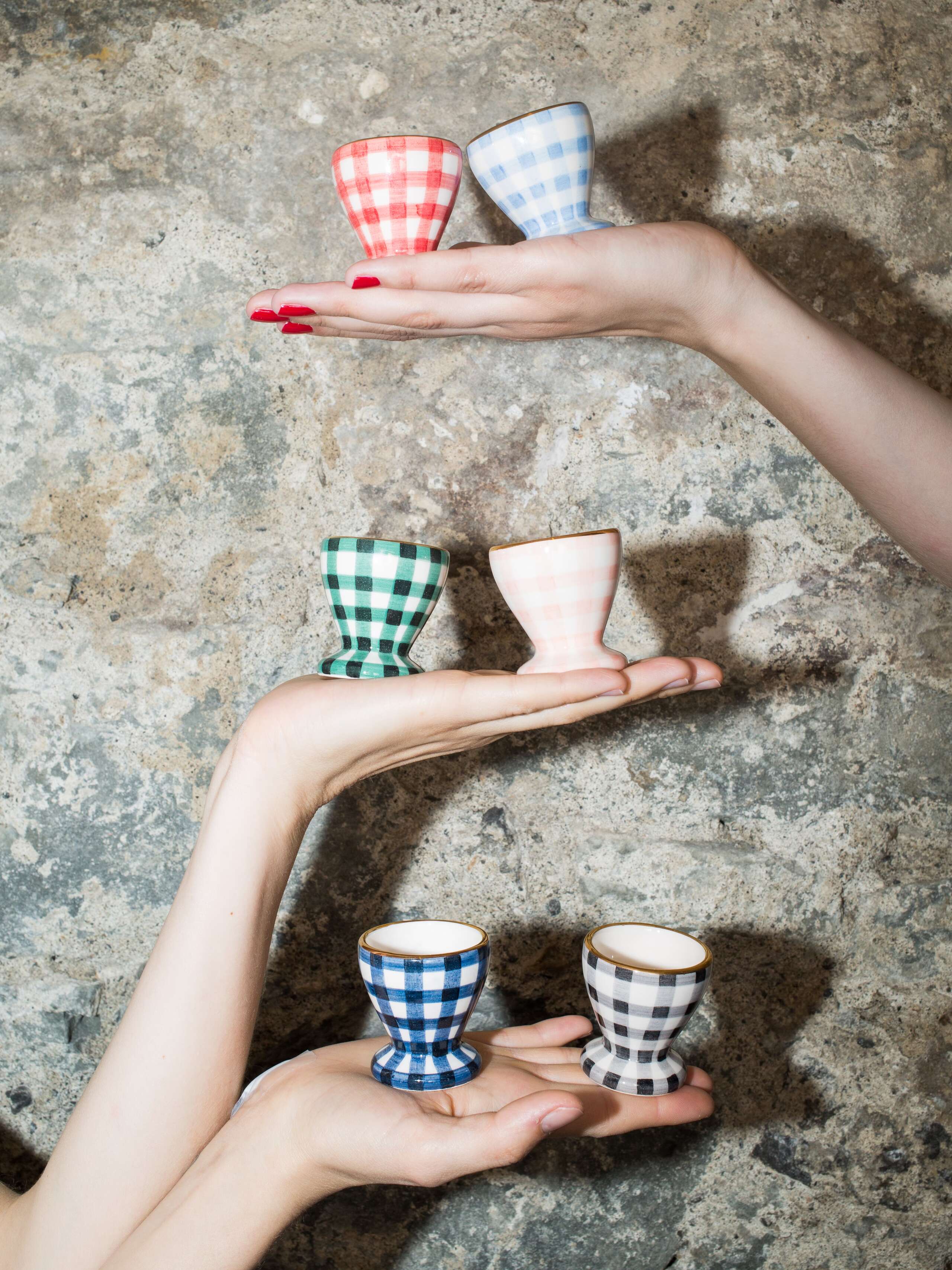 person holding eggcups 