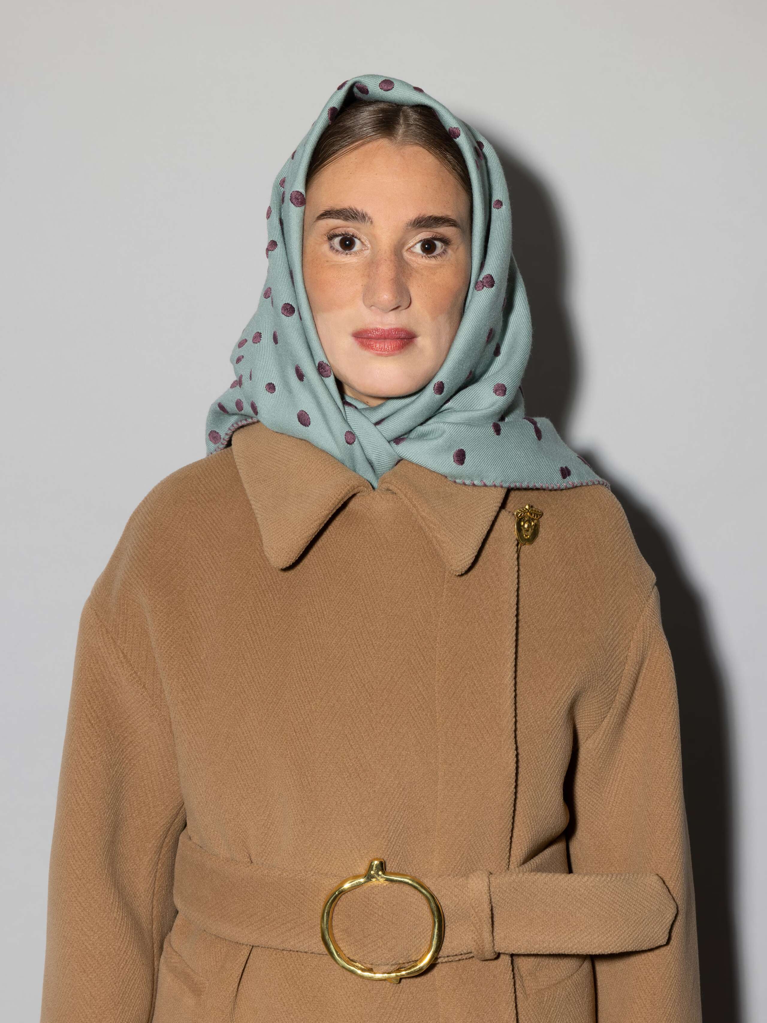 women wearing Leo wool scarf with dots in a light bluish rosemary green an purple embroidery
