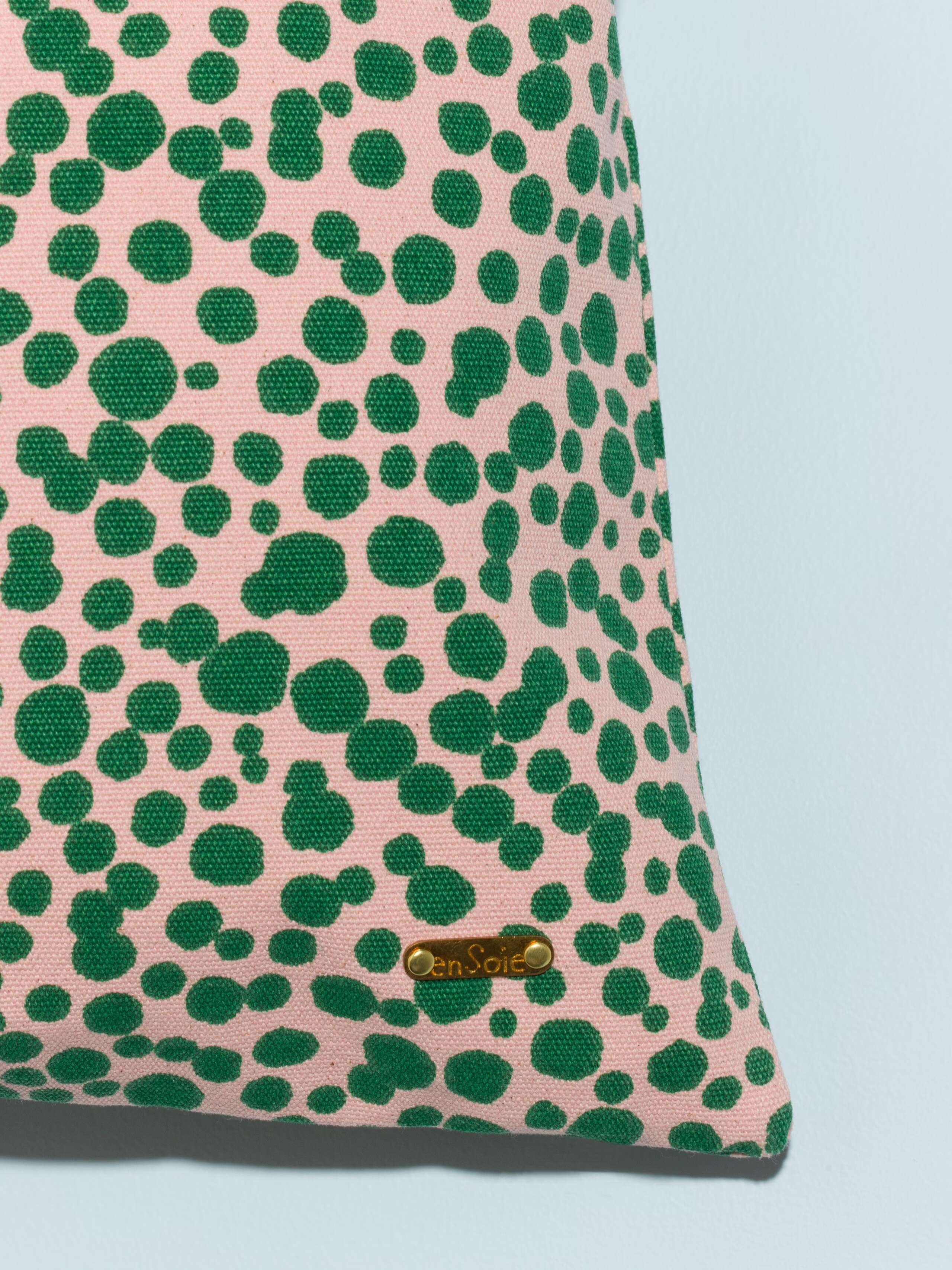pillow cover in pink with green leo dots detail shot brass