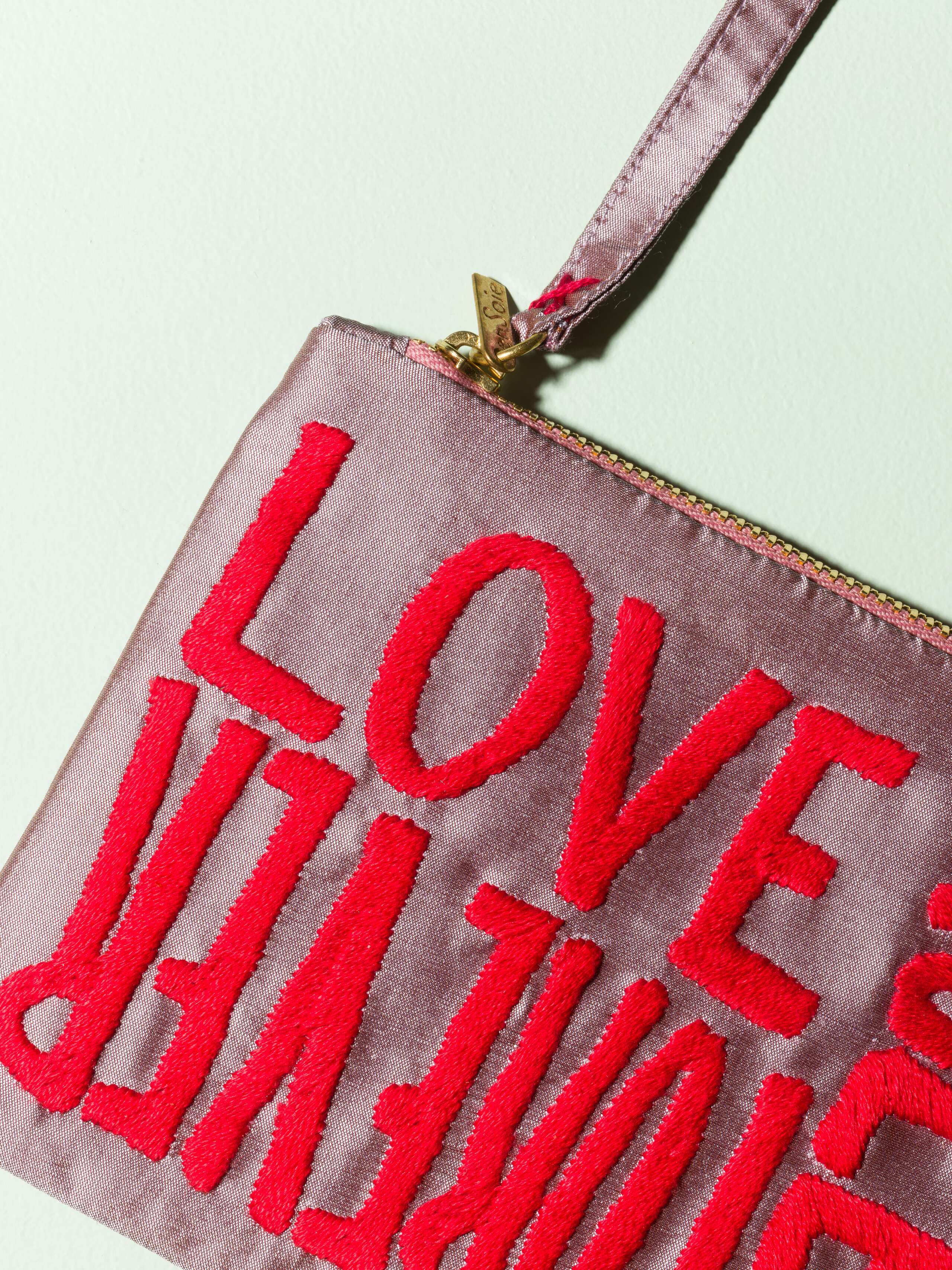 Beautiful silk clutch in a vibrant lavander purple with a pearly gloss and beautiful embroidery LOVE RULES FOREVER in red