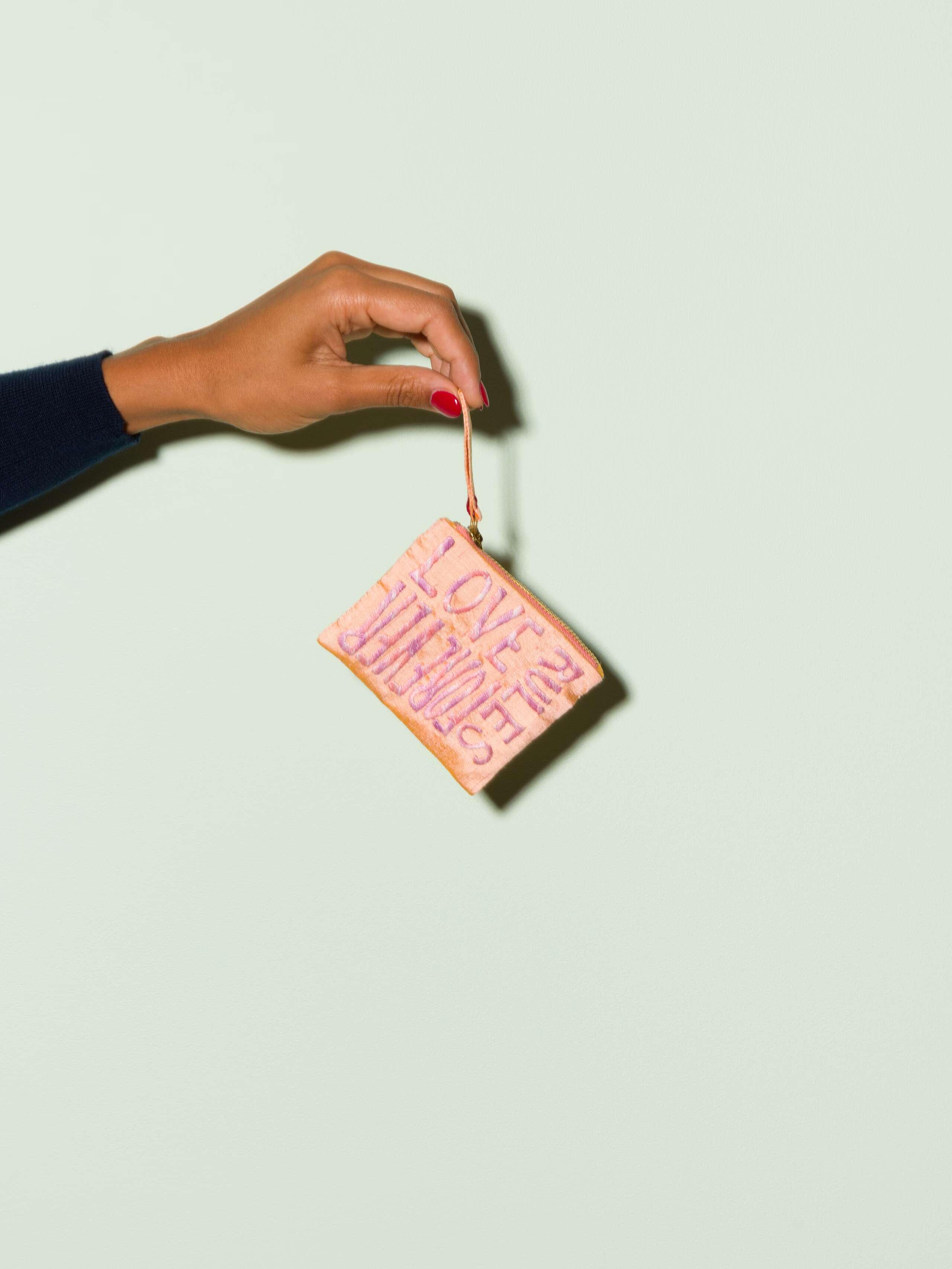 Beautiful silk clutch in a pale orange with a pearly gloss and beautiful embroidery LOVE RULES FOREVER in pink