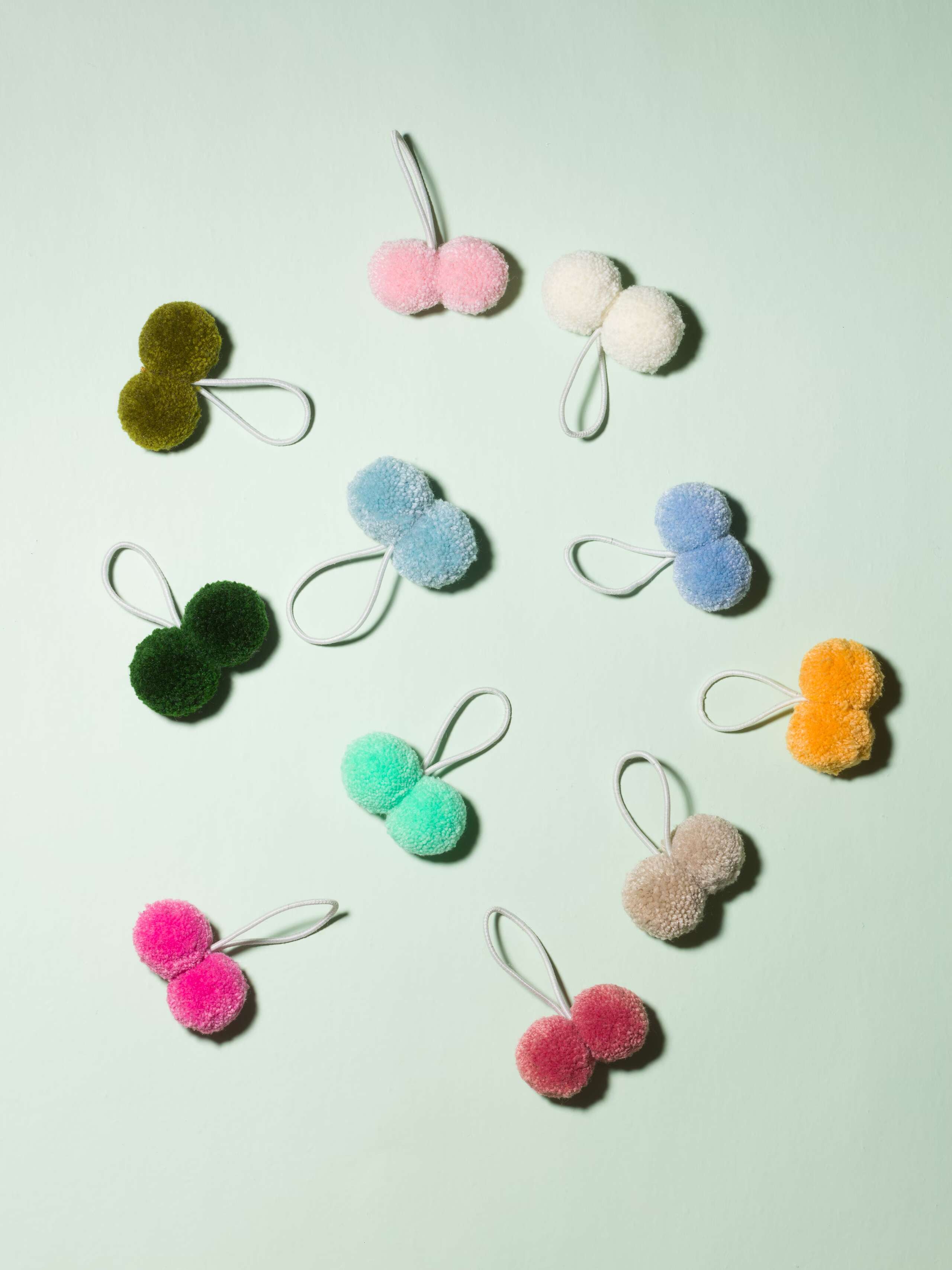 Hair ties with two colourful pompons each