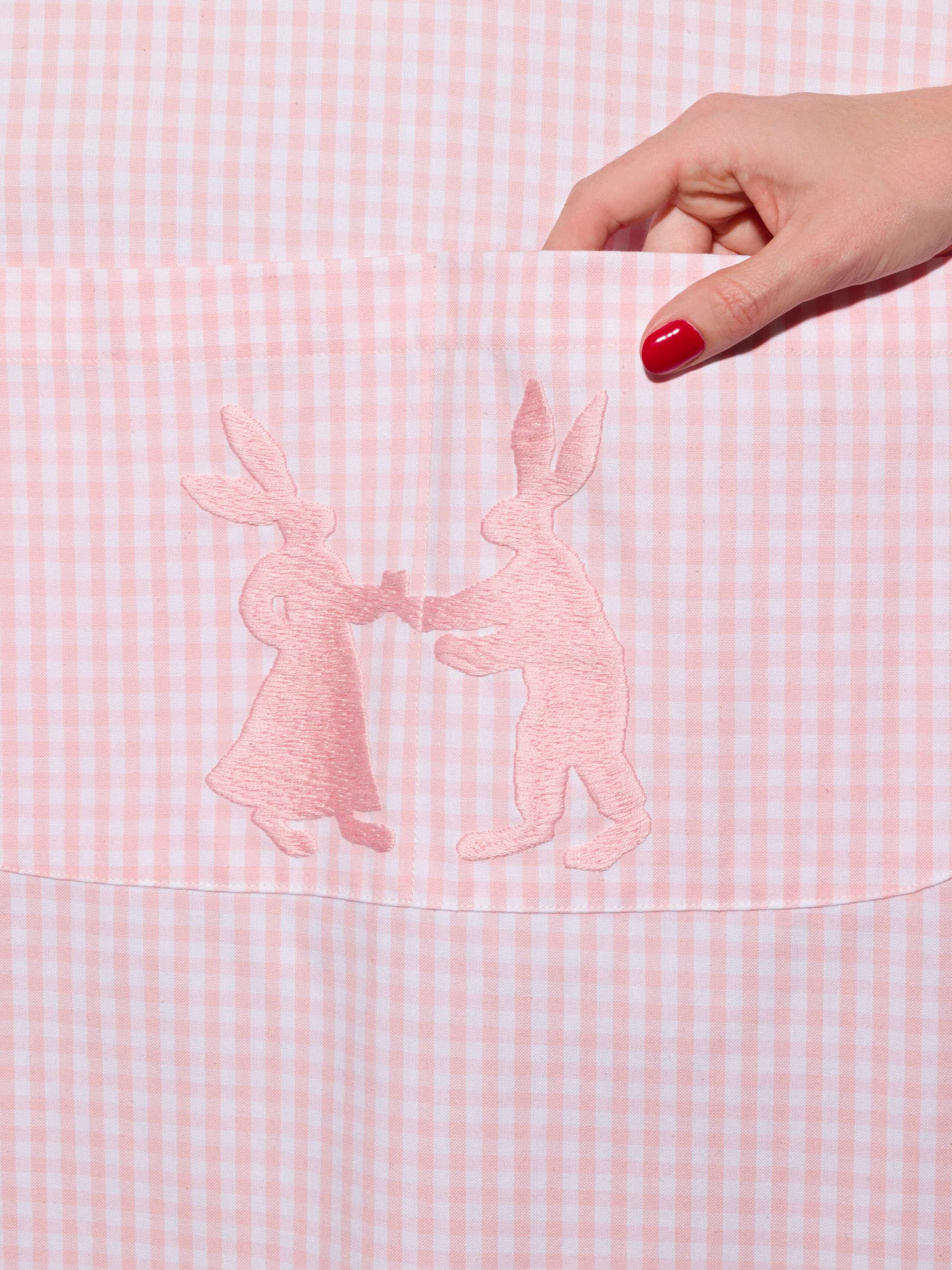 Vichy cotton apron with hand embroidery of dancing rabbits in pink