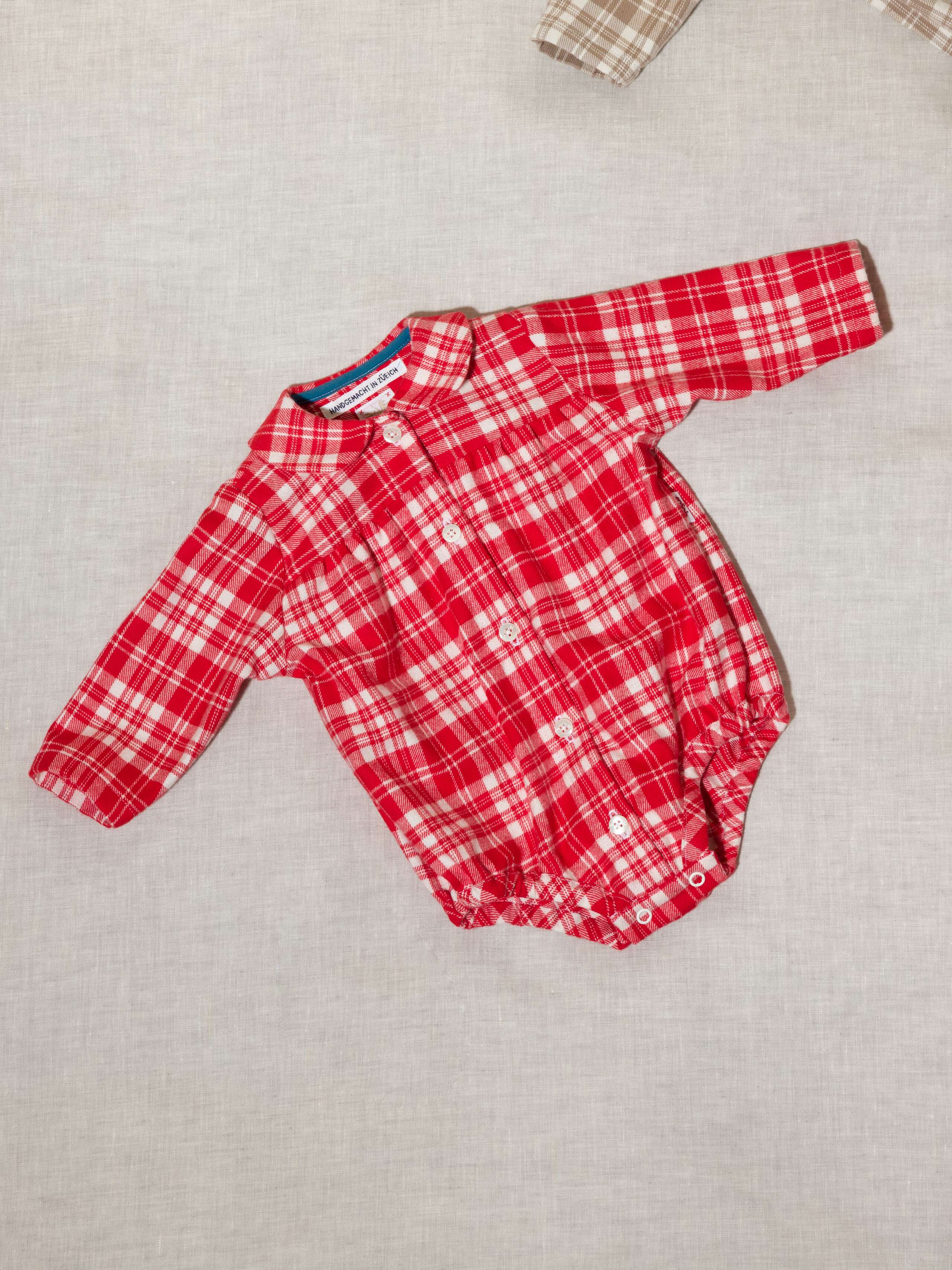 Beautiful handmade cotton flannel baby body in a soft check pattern with long sleeves, red