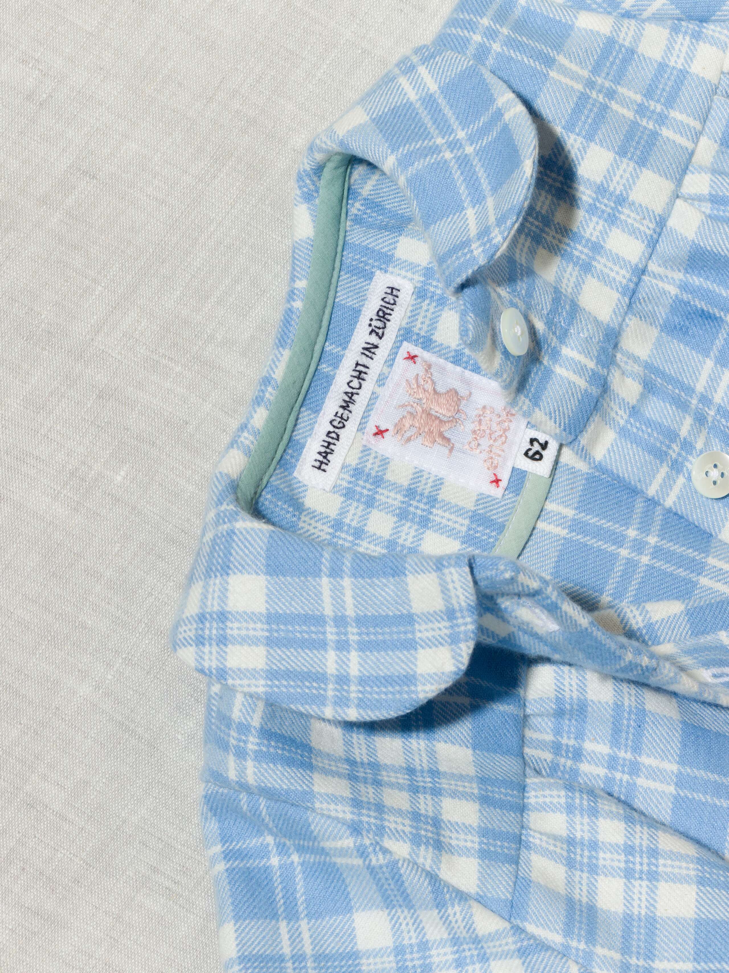 Beautiful handmade cotton flannel baby body in a soft check pattern with long sleeves, light blue