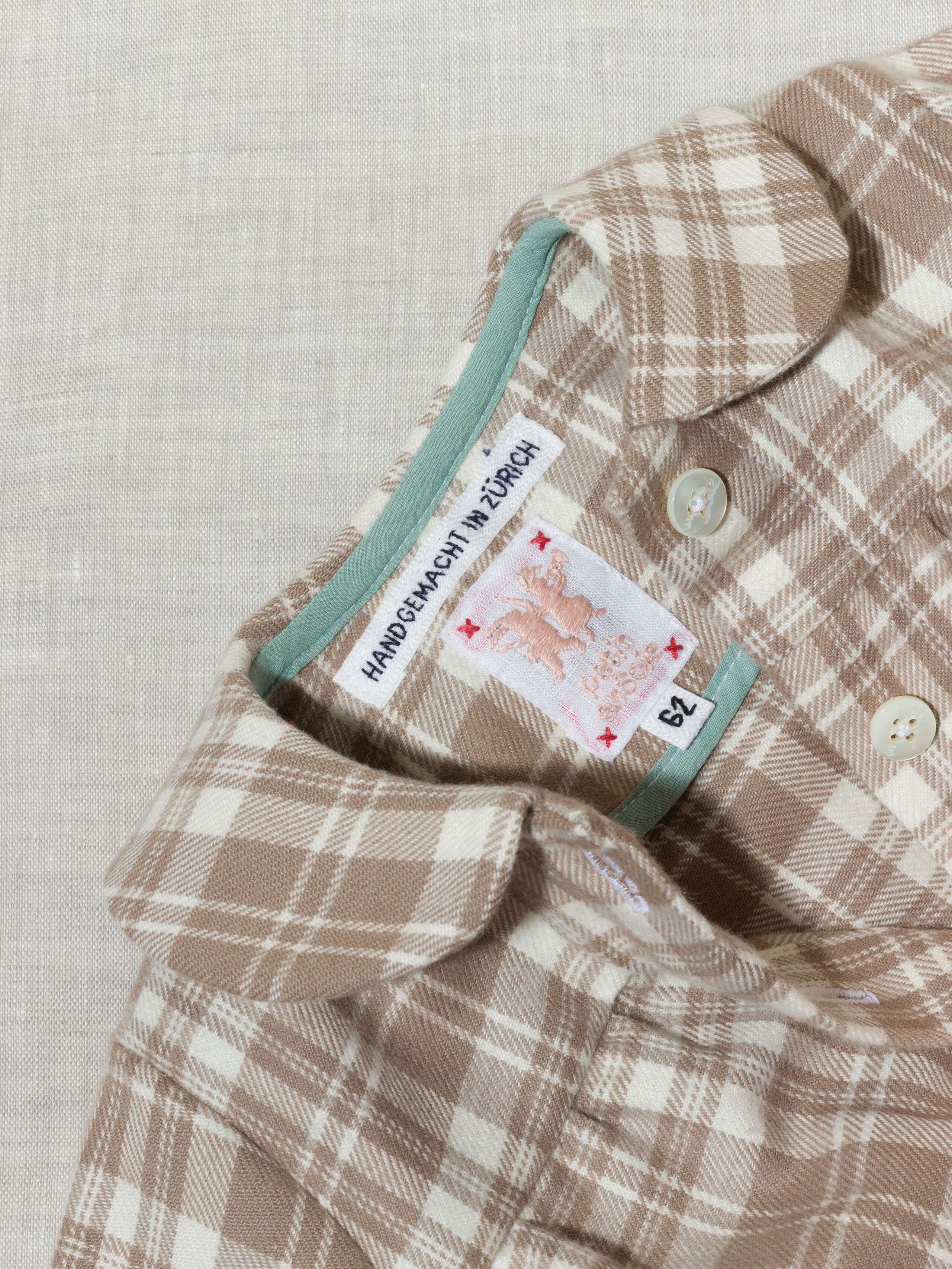 Beautiful handmade cotton flannel baby body in a soft check pattern with long sleeves, moon rock beige