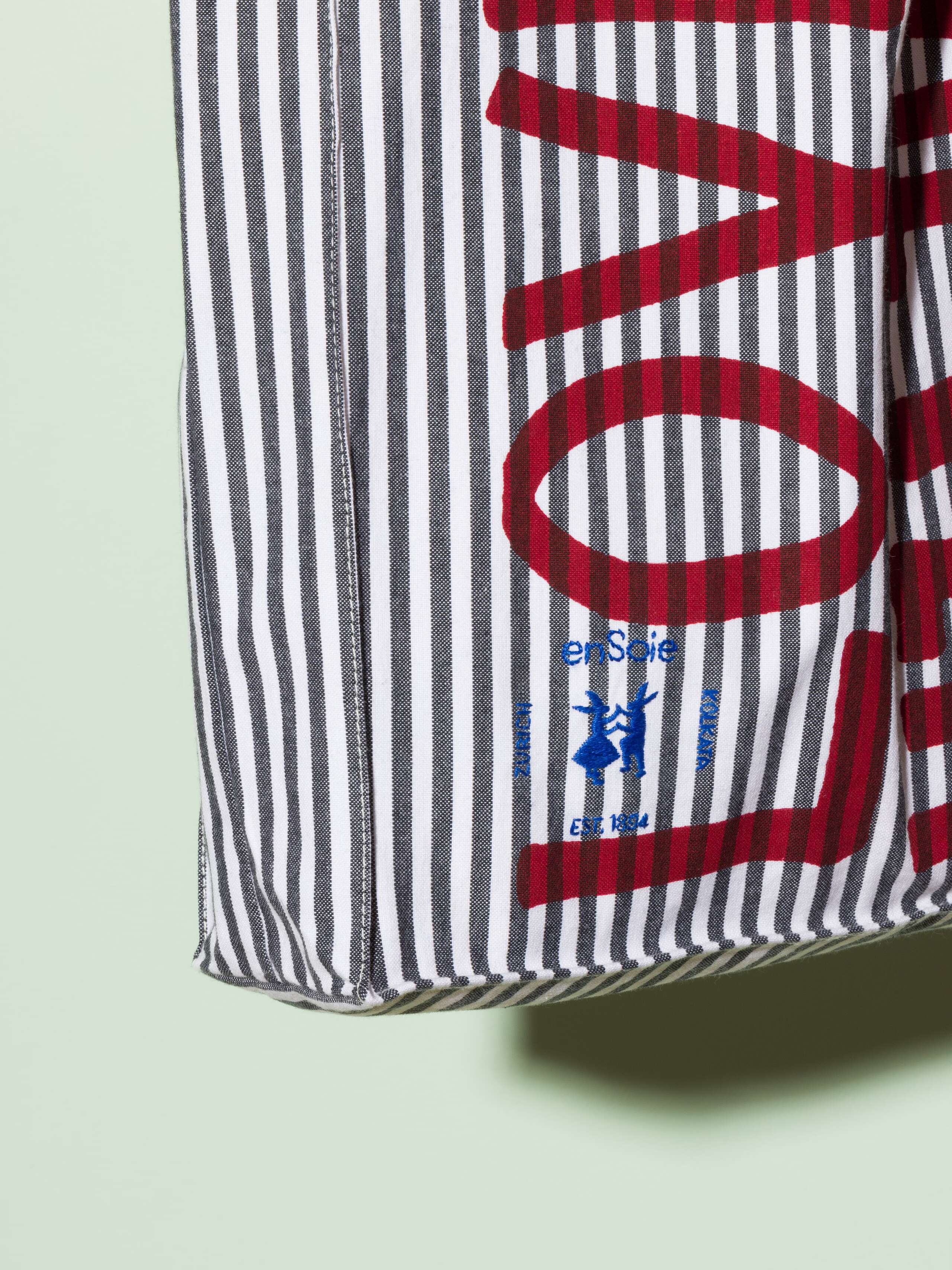  cotton tote bag with a black stripe pattern and a red print that says "Love rules forever" and a rabbit ebroidery