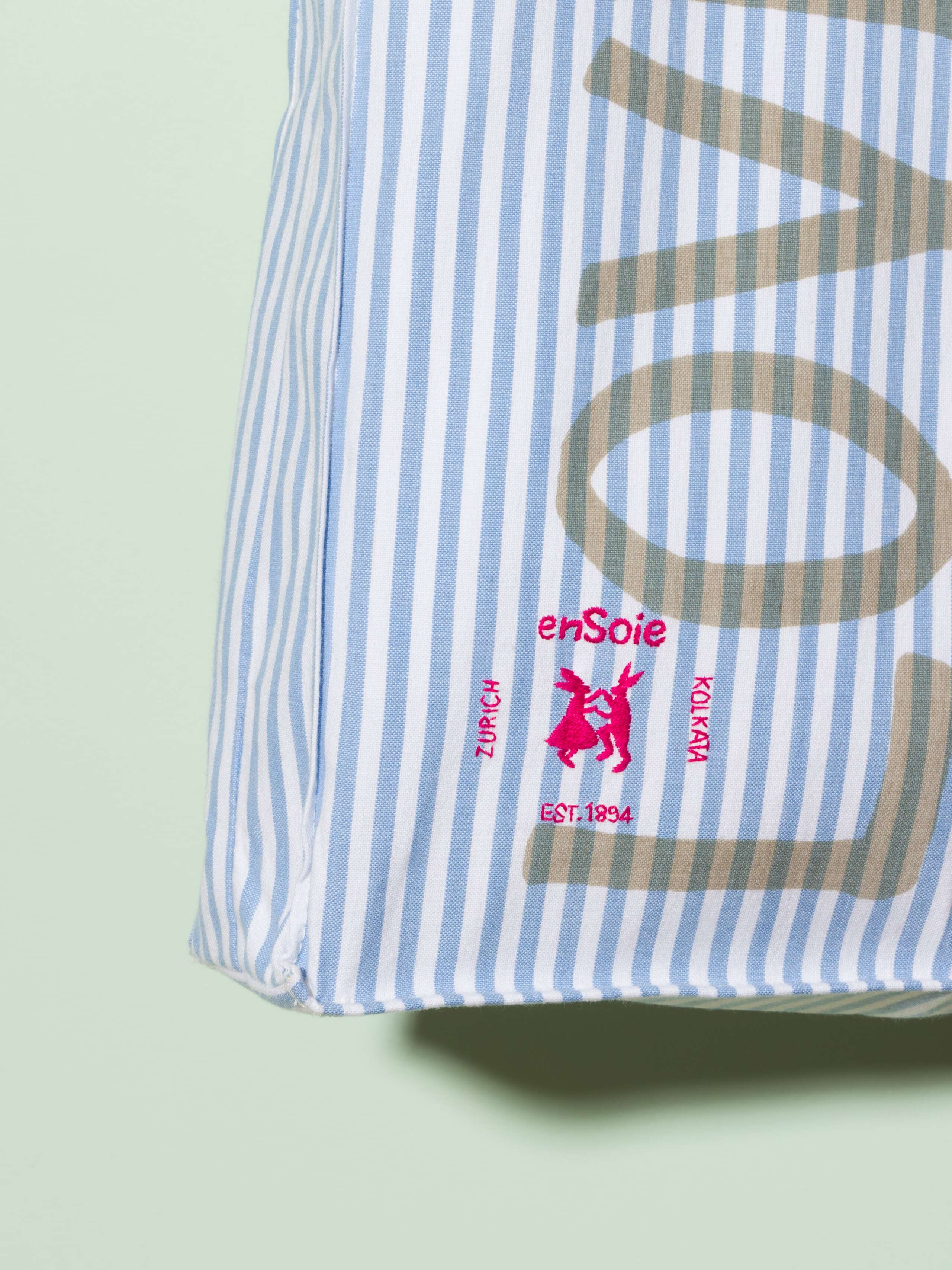  cotton tote bag with a light blue vichy pattern and a beige print that says "Love rules forever" and a rabbit ebroidery
