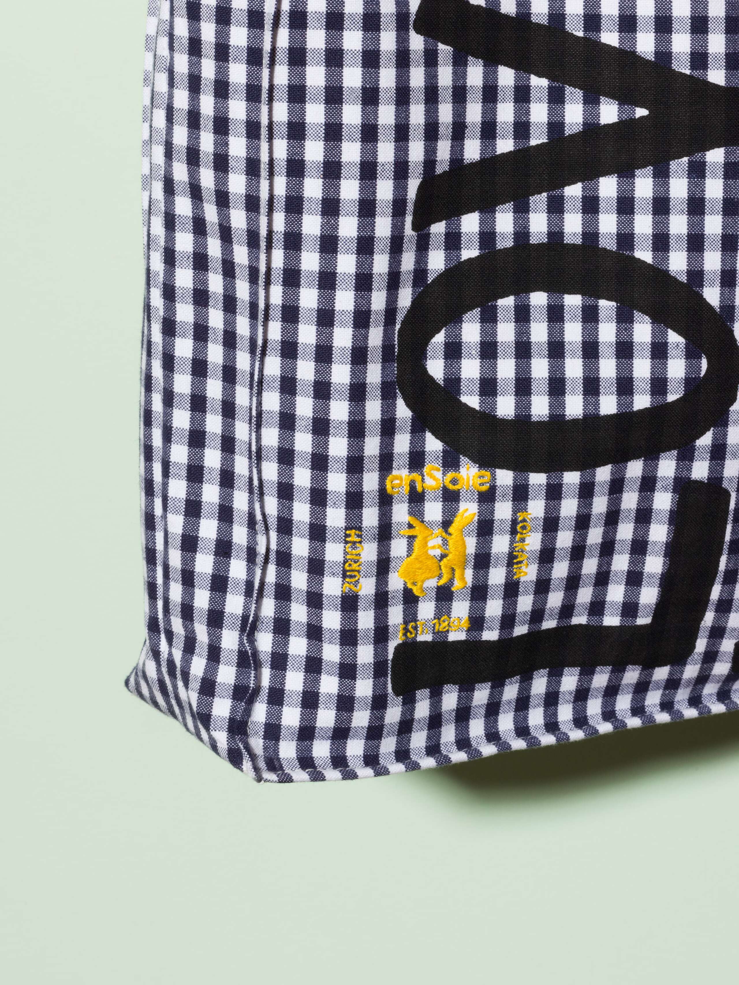  cotton tote bag with a navy vichy pattern and a black print that says "Love rules forever" and a rabbit ebroidery