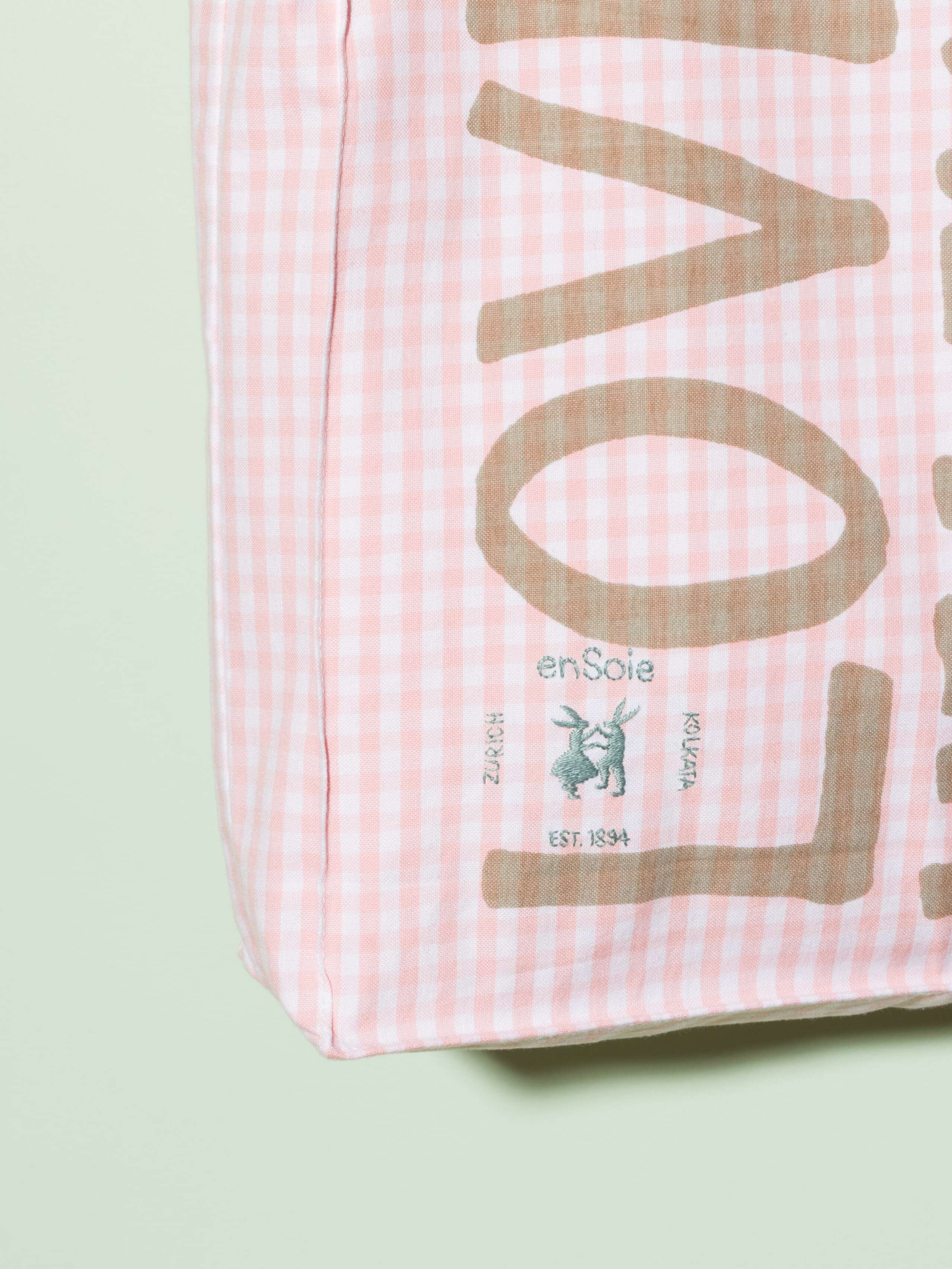  cotton tote bag with a pink vichy pattern and a beige print that says "Love rules forever" and a rabbit ebroidery