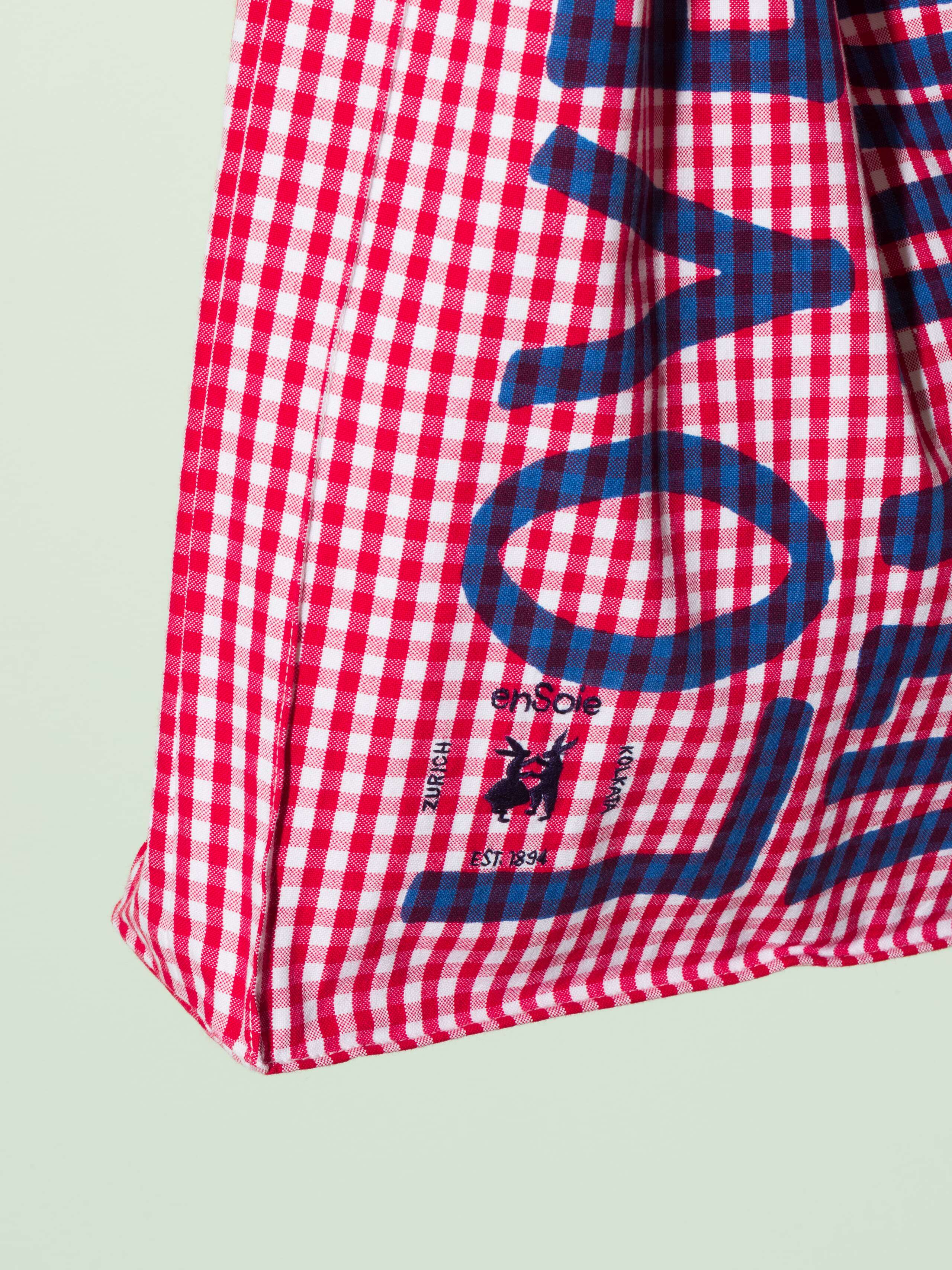  cotton tote bag with a red vichy pattern and a navy print that says "Love rules forever" and a rabbit ebroidery