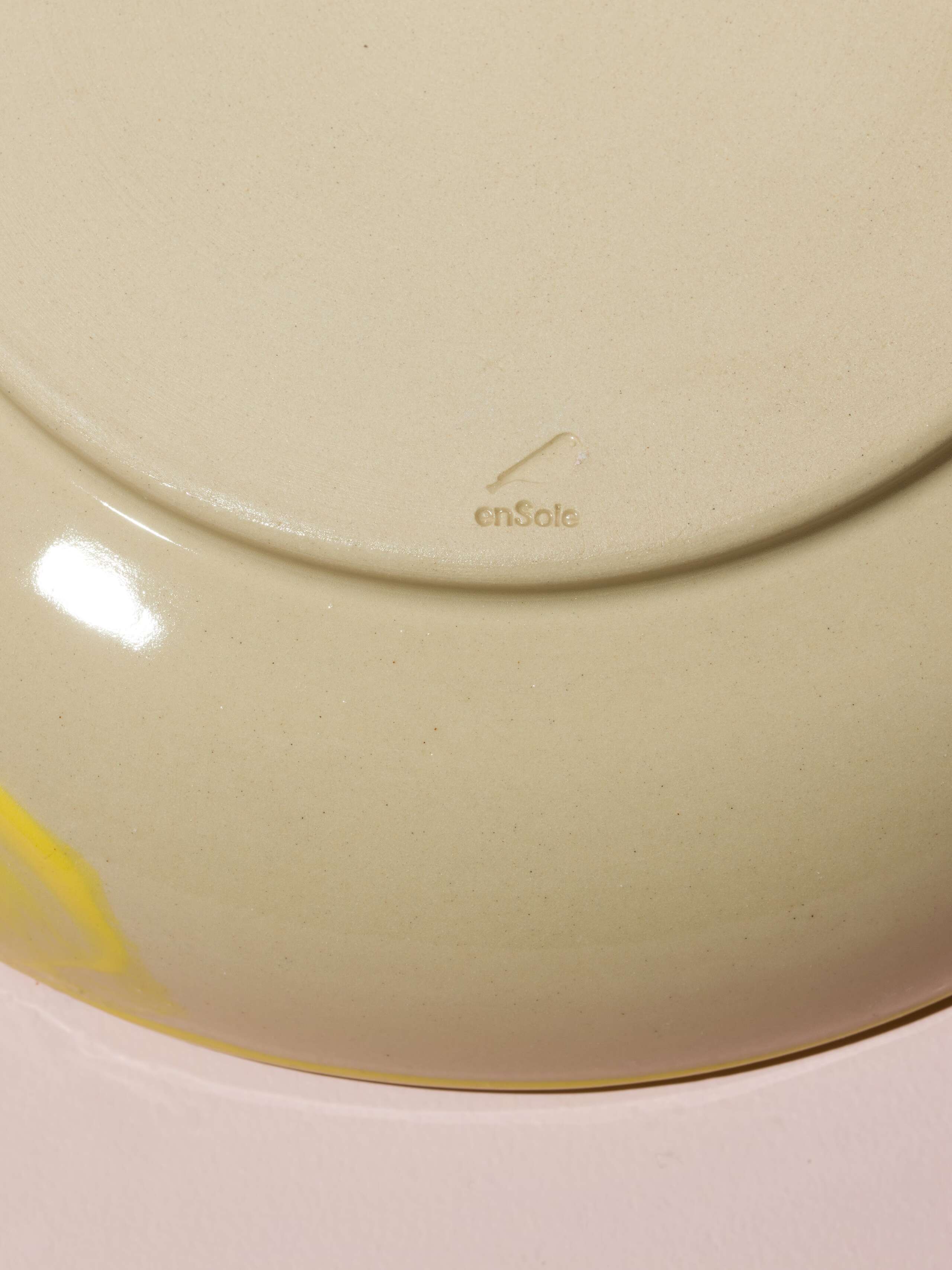 Detail of a hand painted plate in beautiful colour shades of blue, yellow, red and black