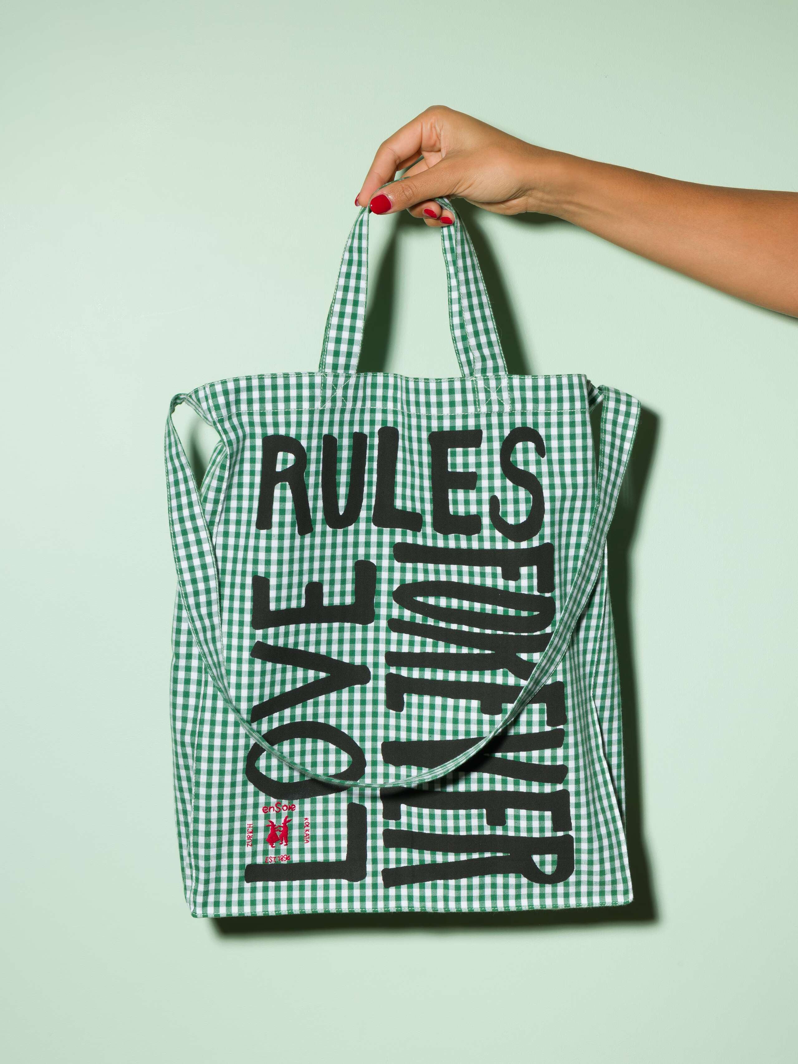  cotton tote bag with a green vichy pattern and a black print that says "Love rules forever" and a rabbit ebroidery