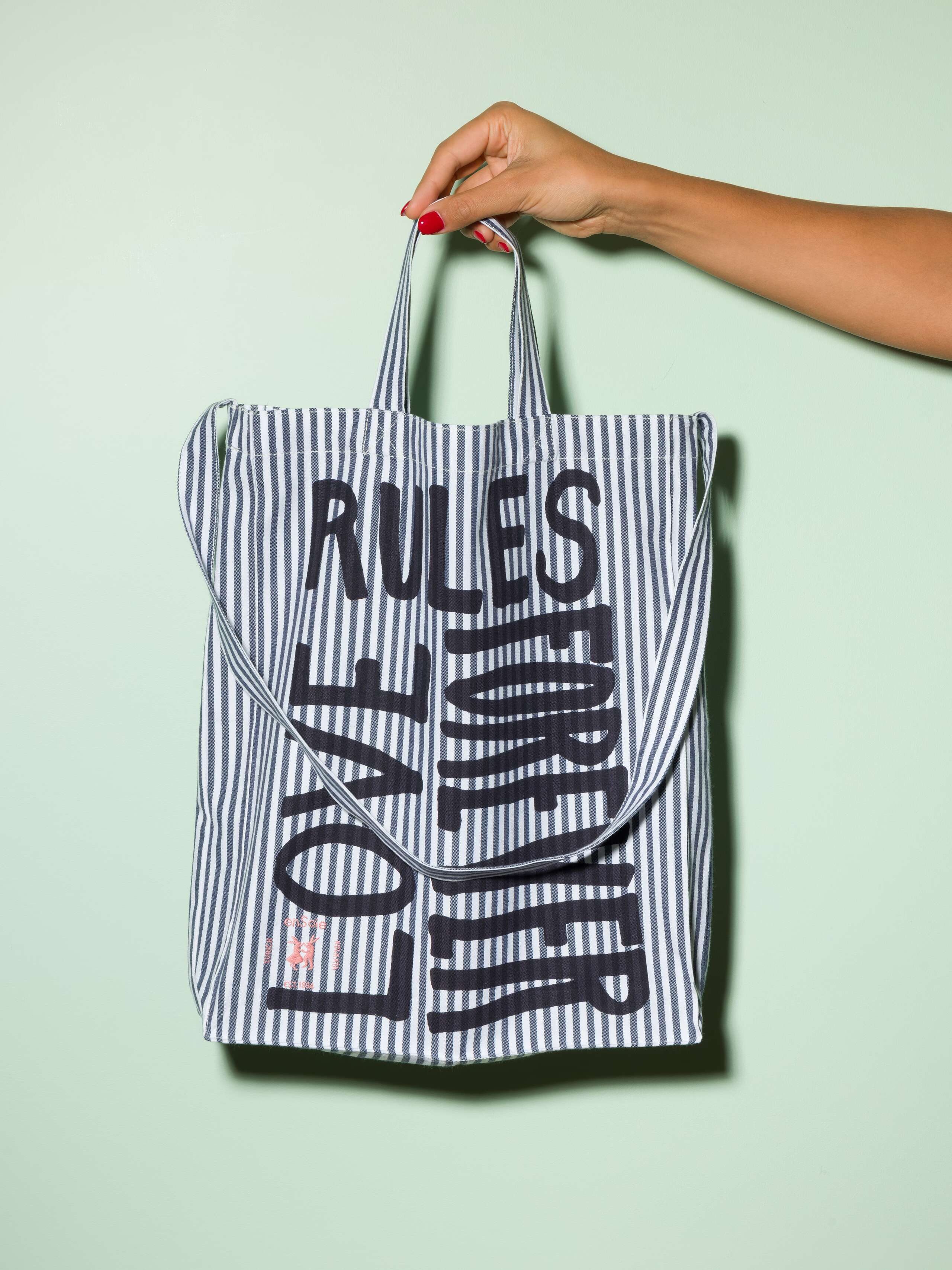  cotton tote bag with a navy stripe pattern and a black print that says "Love rules forever" and a rabbit ebroidery