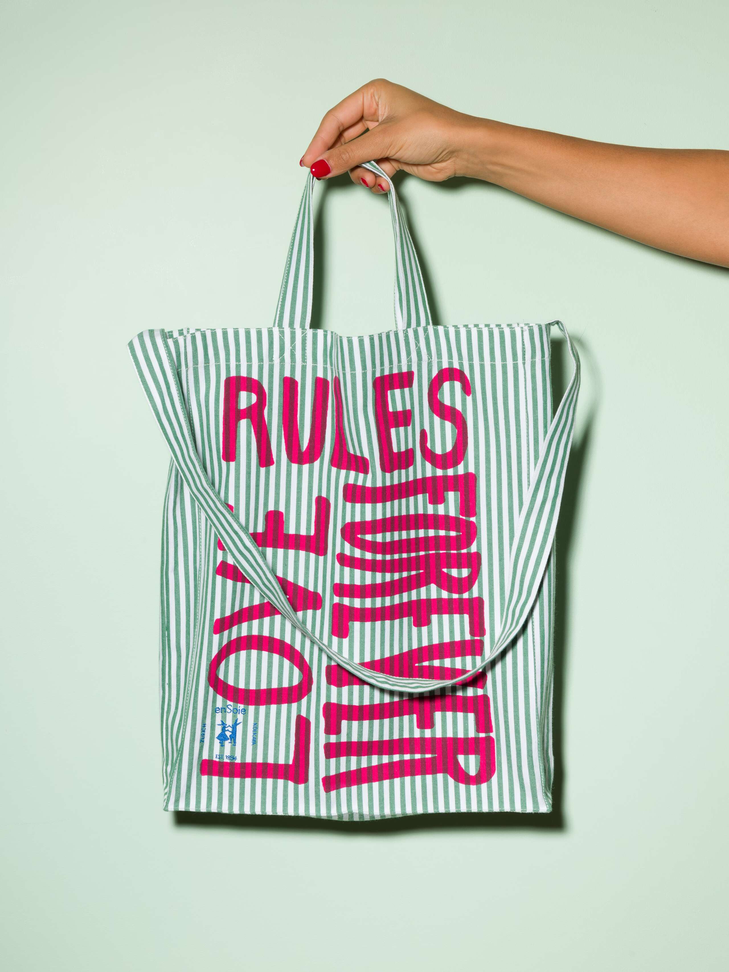  cotton tote bag with a green stripe pattern and a pink print that says "Love rules forever" and a rabbit ebroidery
