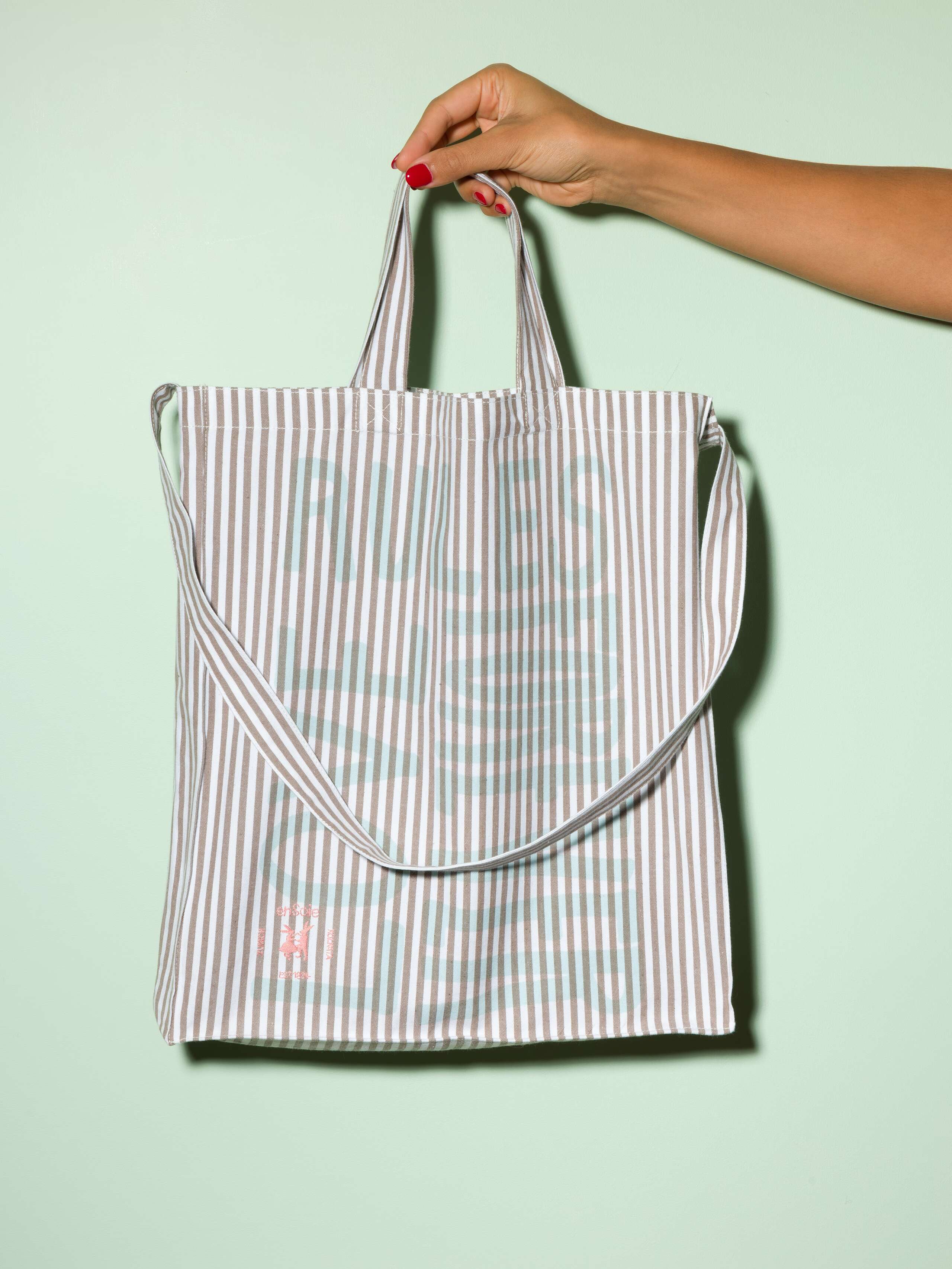  cotton tote bag with a beige stripe pattern and a mint print that says "Love rules forever" and a rabbit ebroidery