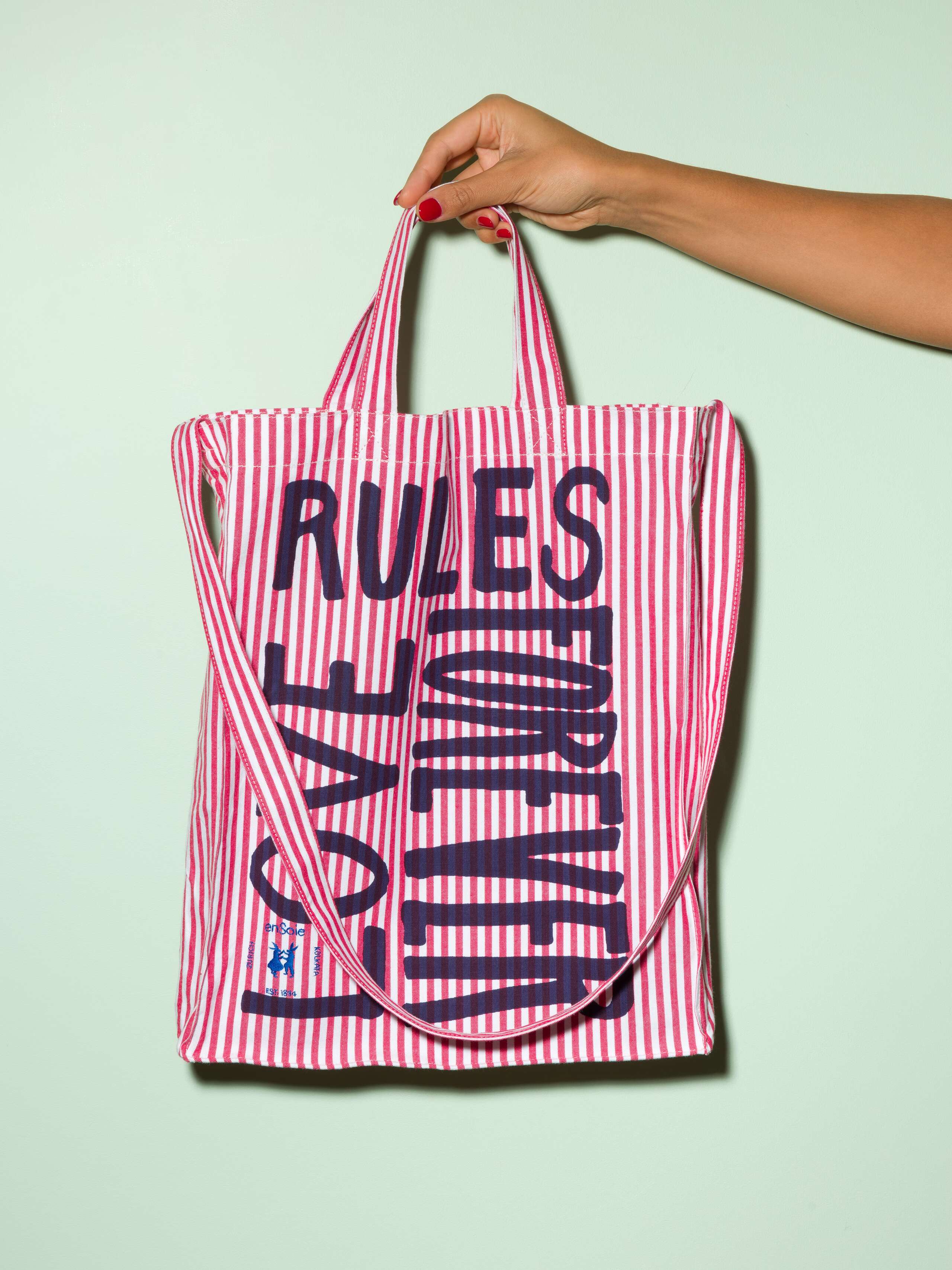  cotton tote bag with a red stripe pattern and a navy print that says "Love rules forever" and a rabbit ebroidery