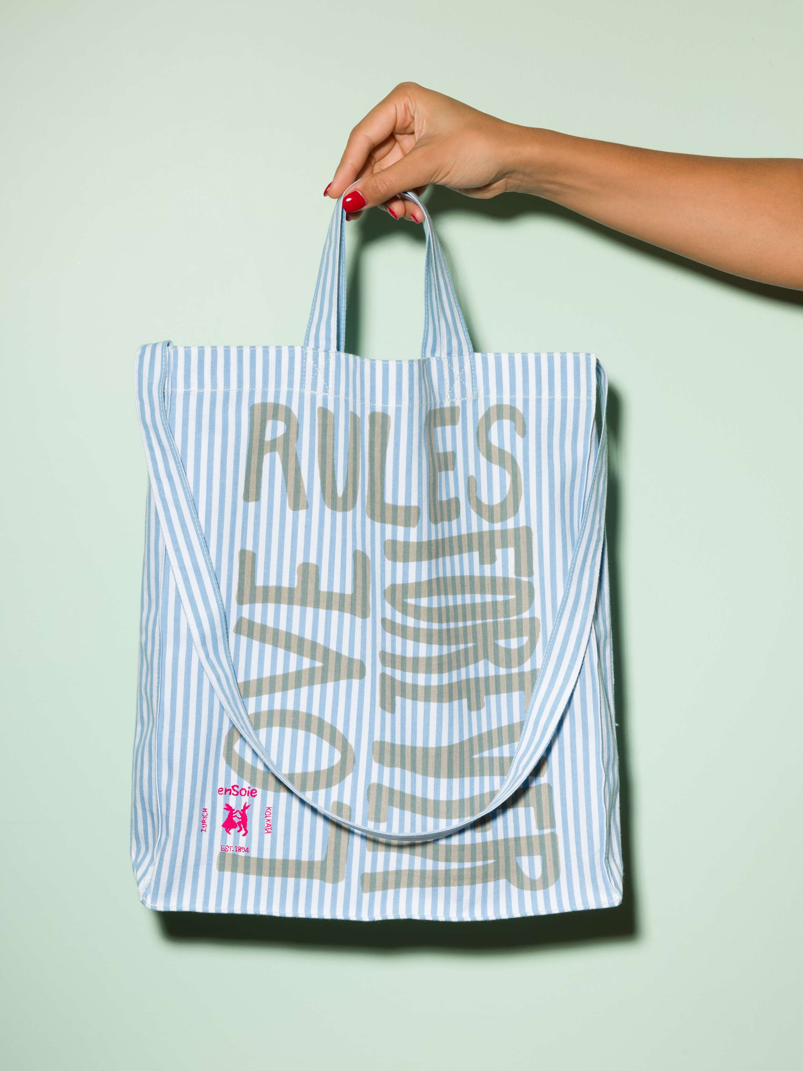  cotton tote bag with a light blue stripe pattern and a beige print that says "Love rules forever" and a rabbit ebroidery