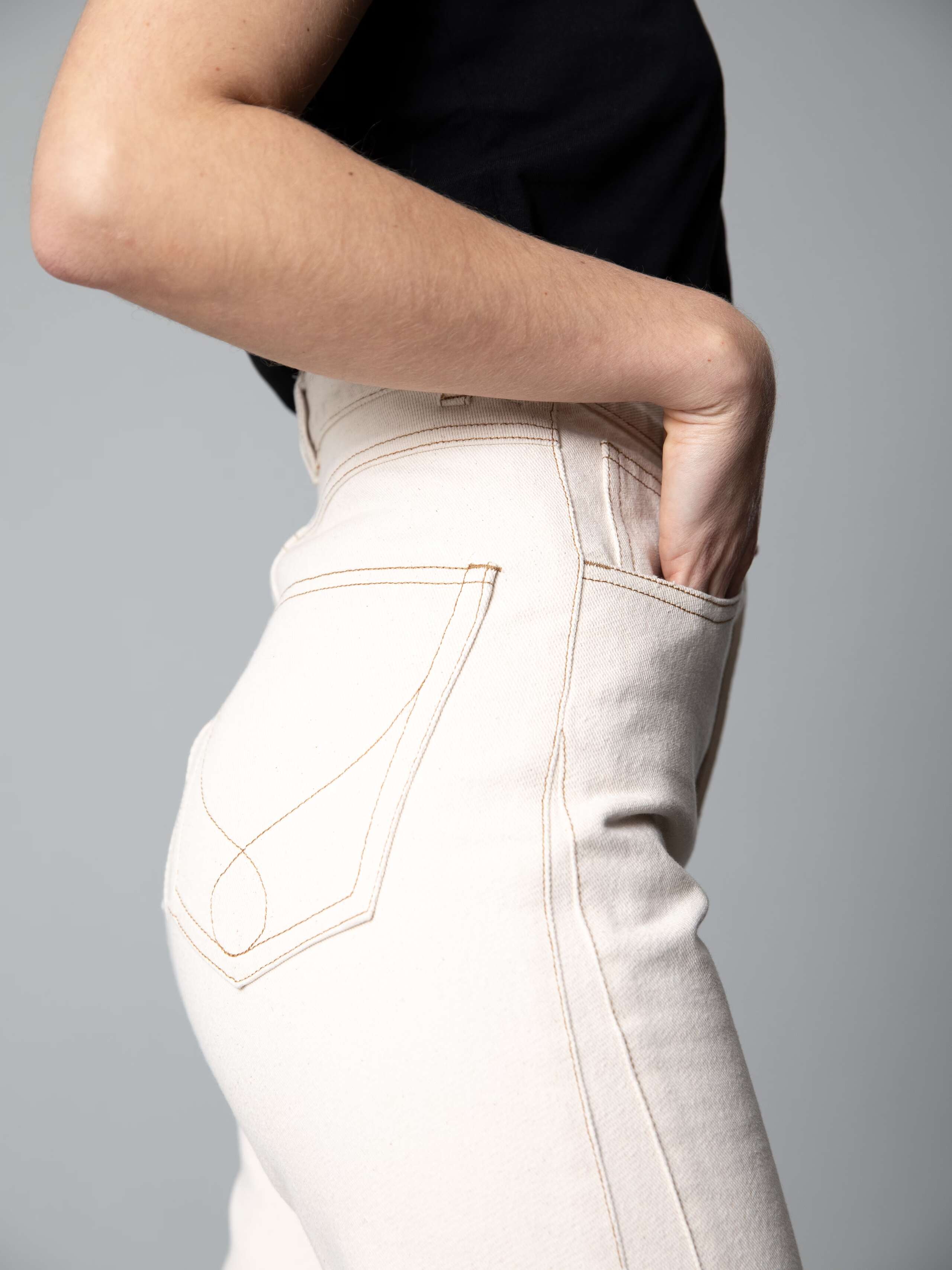 Detail of a beautiful high waist jeans in a ecru colour