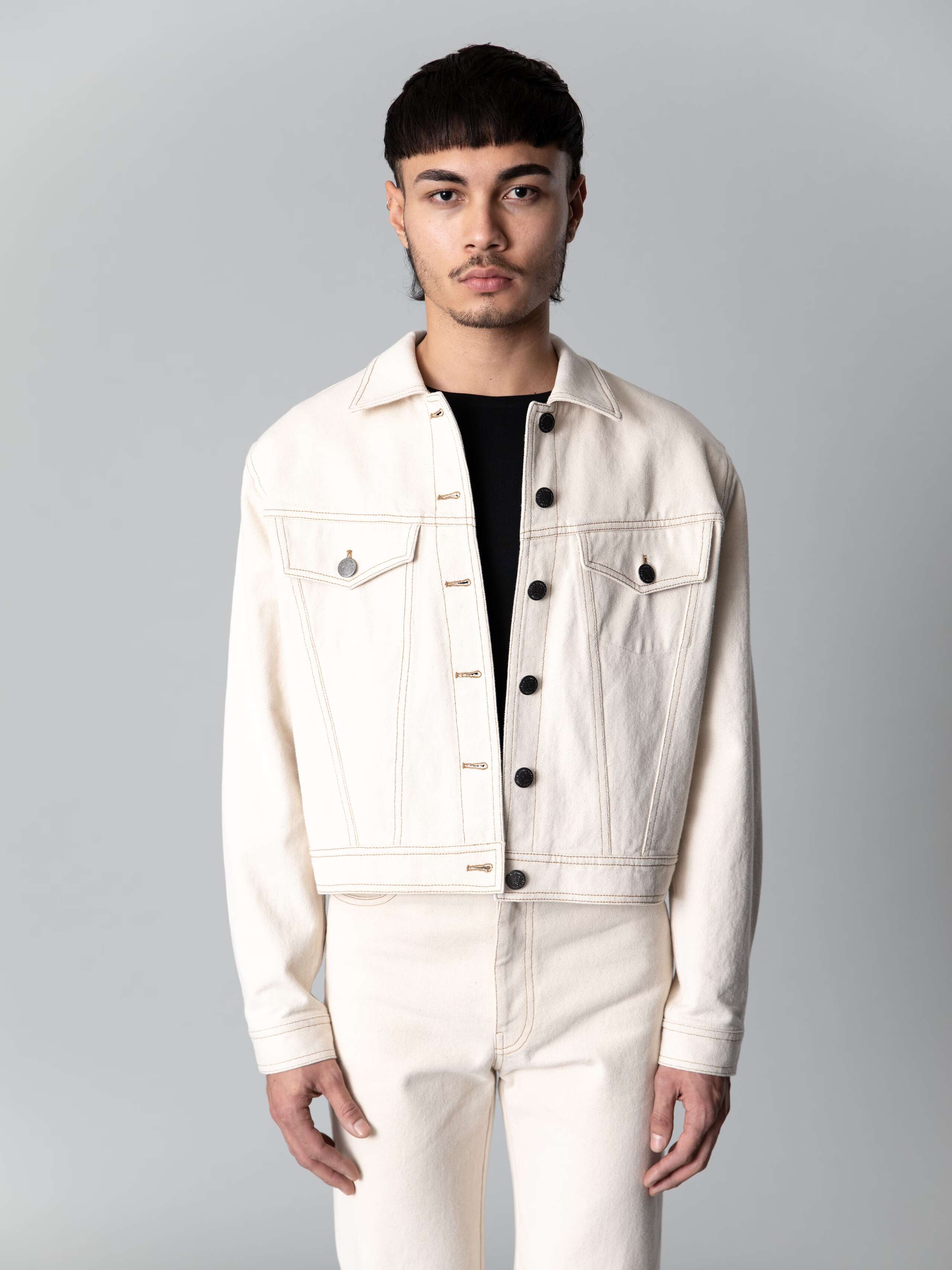 Male model is wearing a cool boxy denim jacket in a nice ecru colour shade