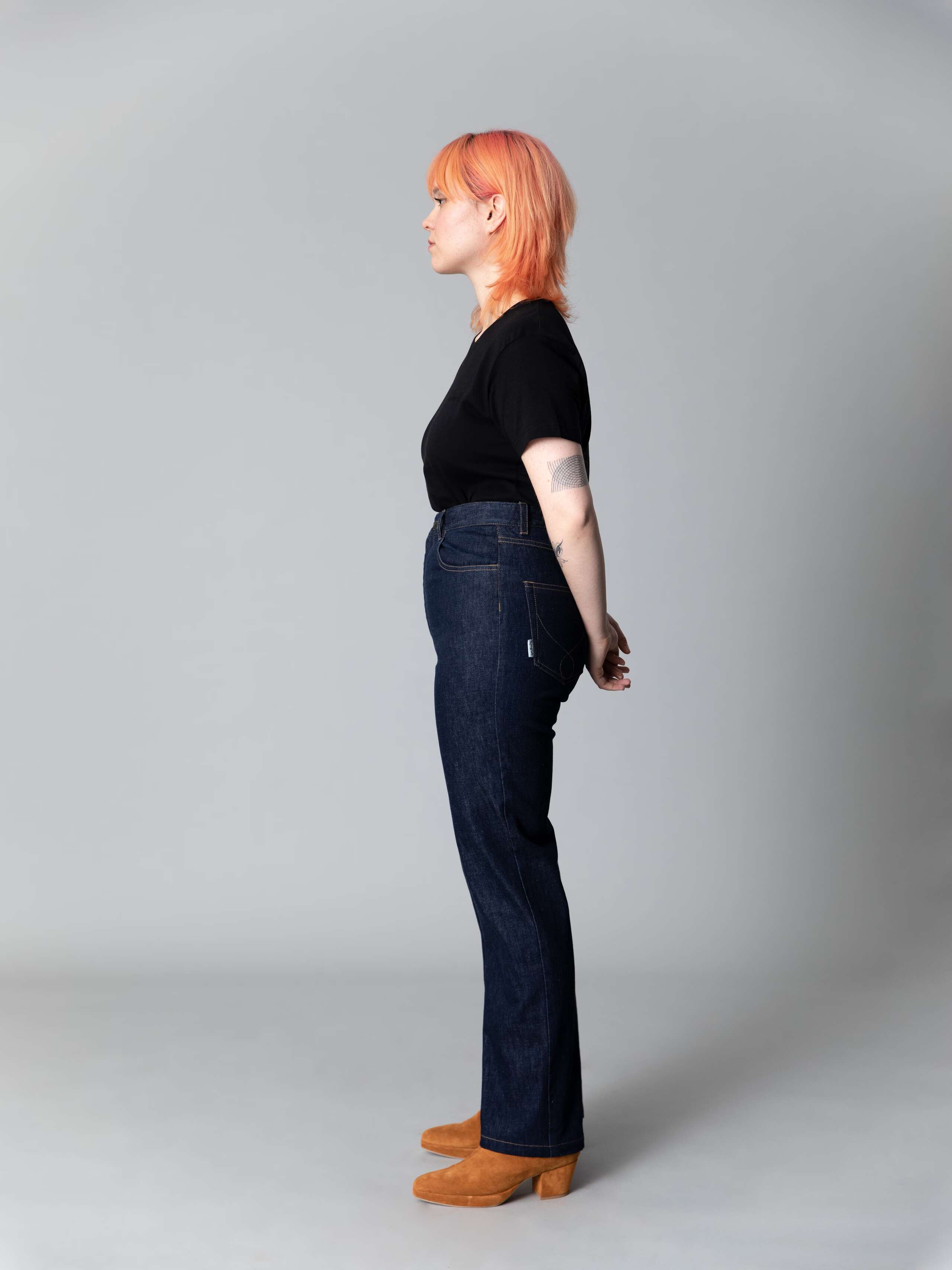 Model wears a beautiful straight leg high waist jeans in indigo blue