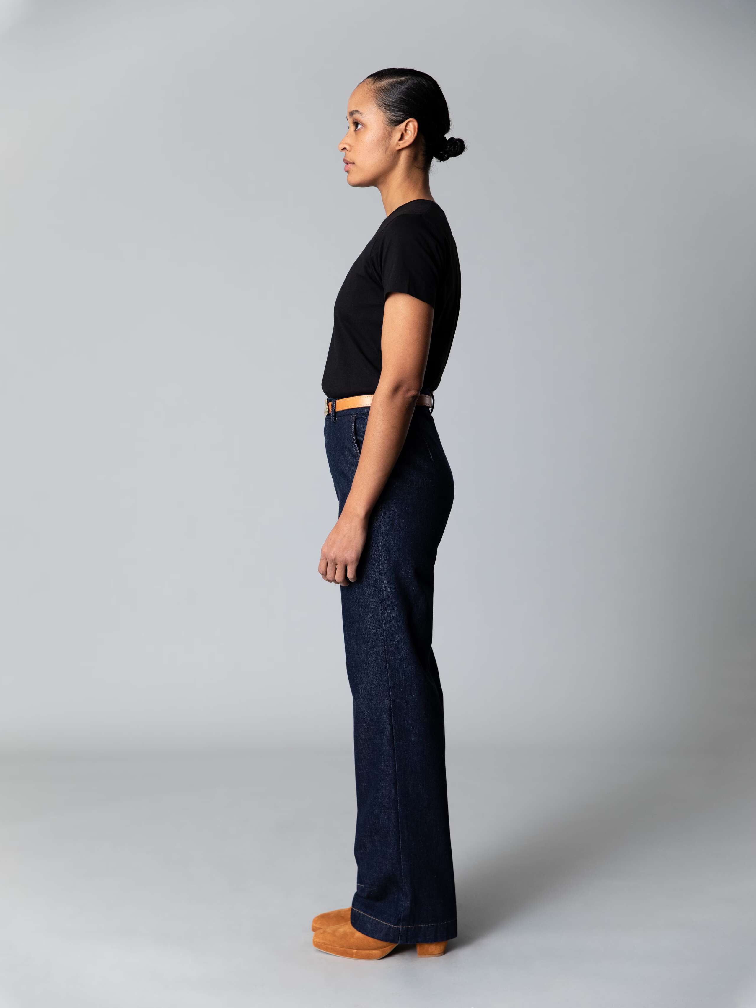 Model is weraing a cotton denim high waist jeans in a classy indigo colour combined with a white shirt and black ballerina flats 