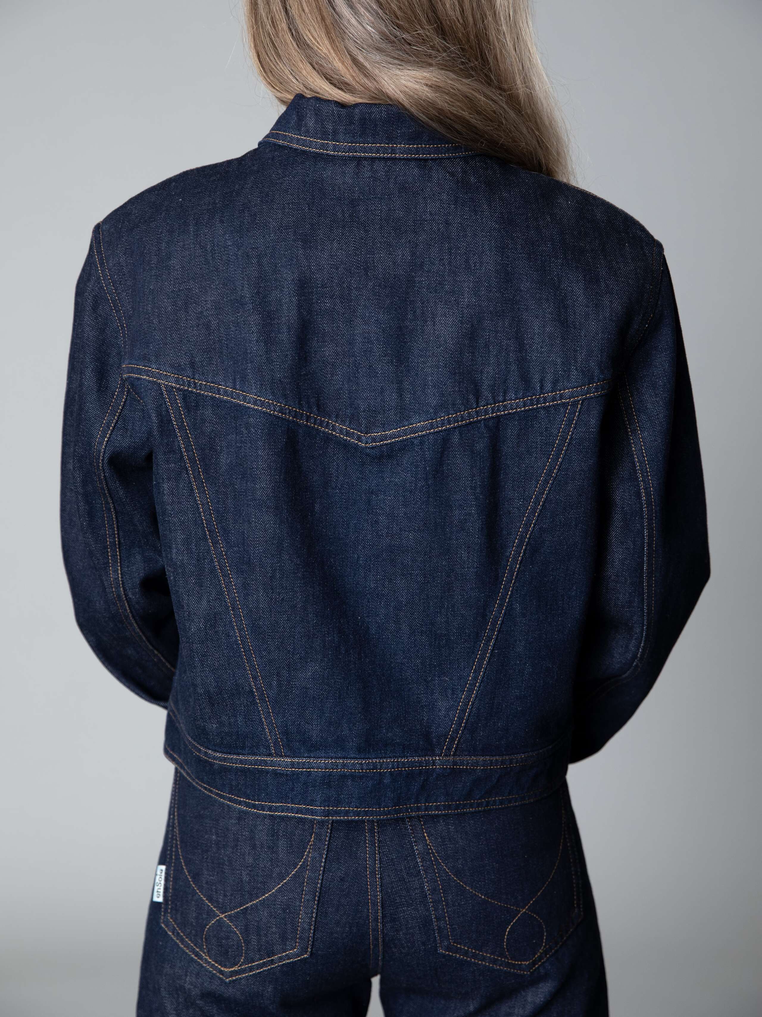 Model is wearing a beautiful wide leg jeans in dark indigo with a matching boxy denim jacket