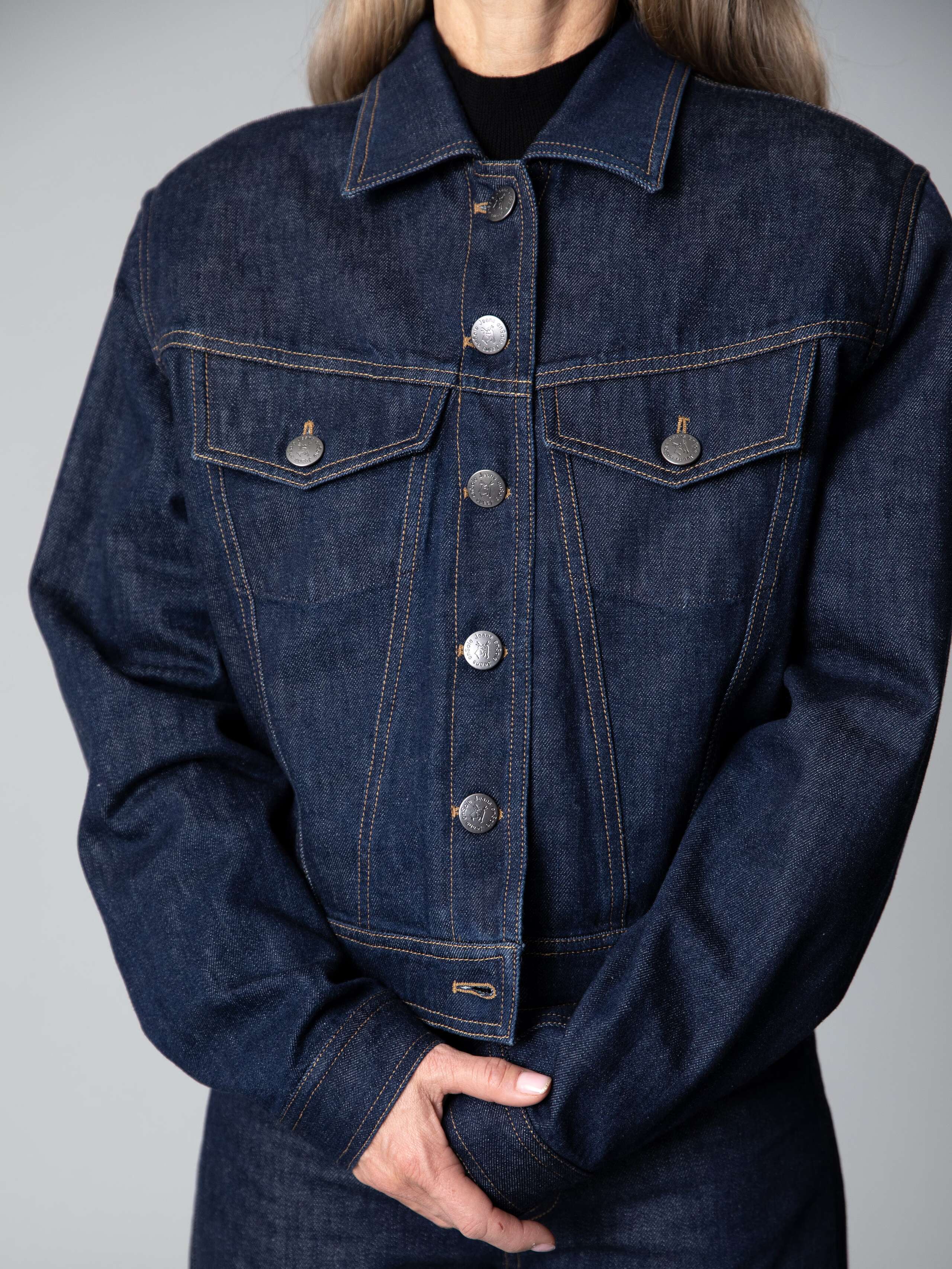Details of a boxy denim jacket in dark indigo 