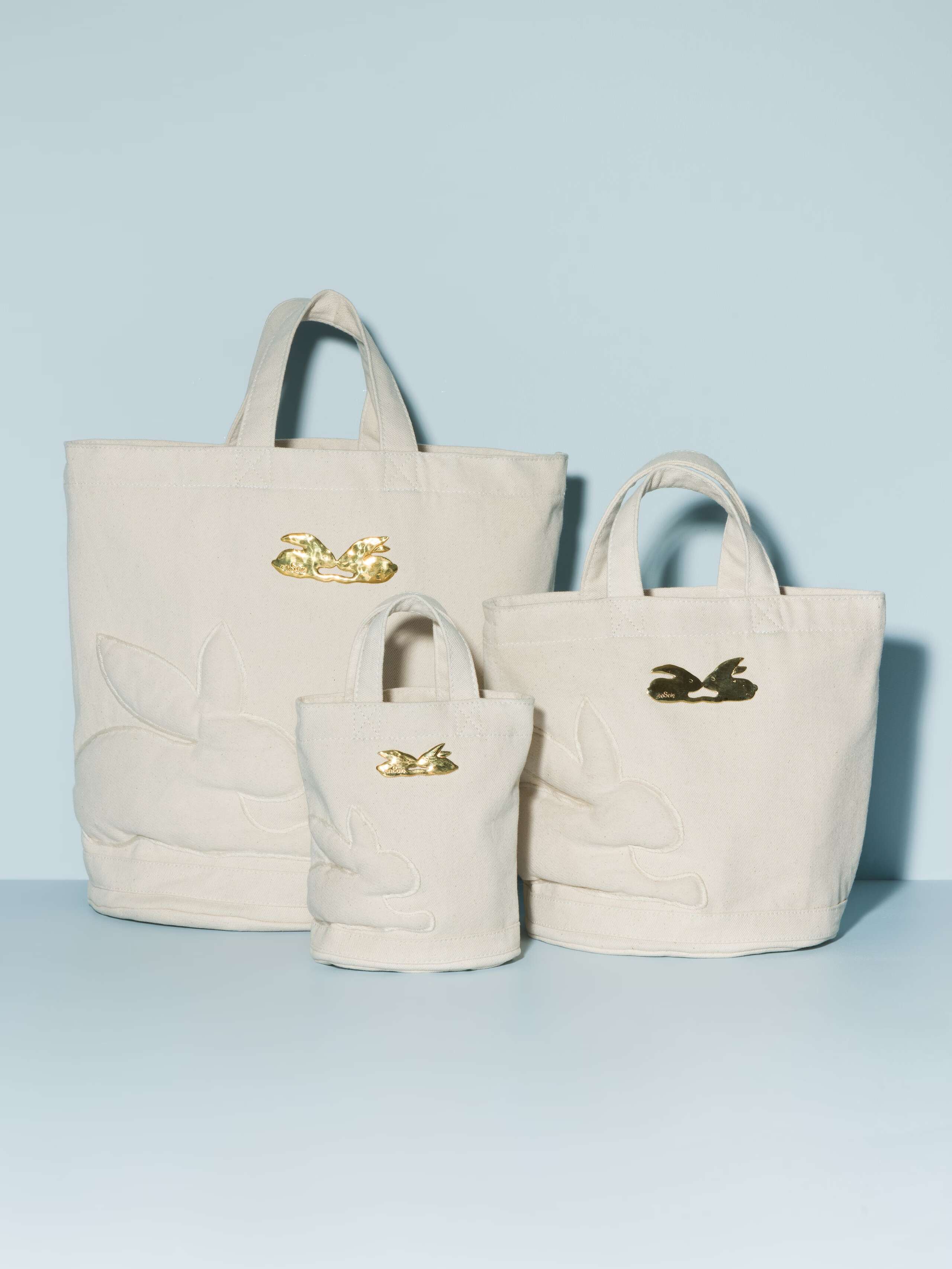 Three denim bags in different sizes in a beautiful ecru with a beautiful rabbit brass tag