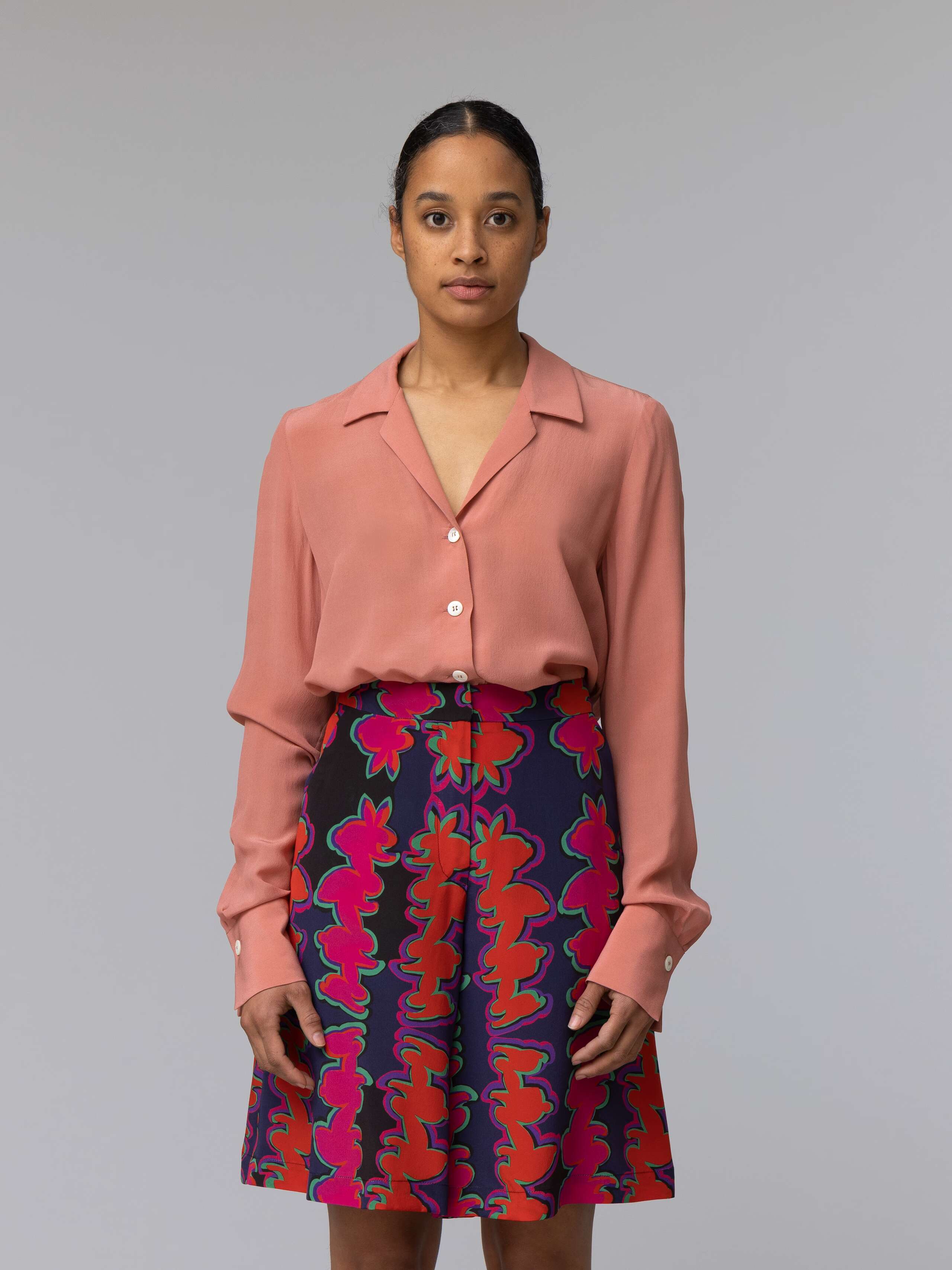 Model wears a long terracotta colour silk blouse 