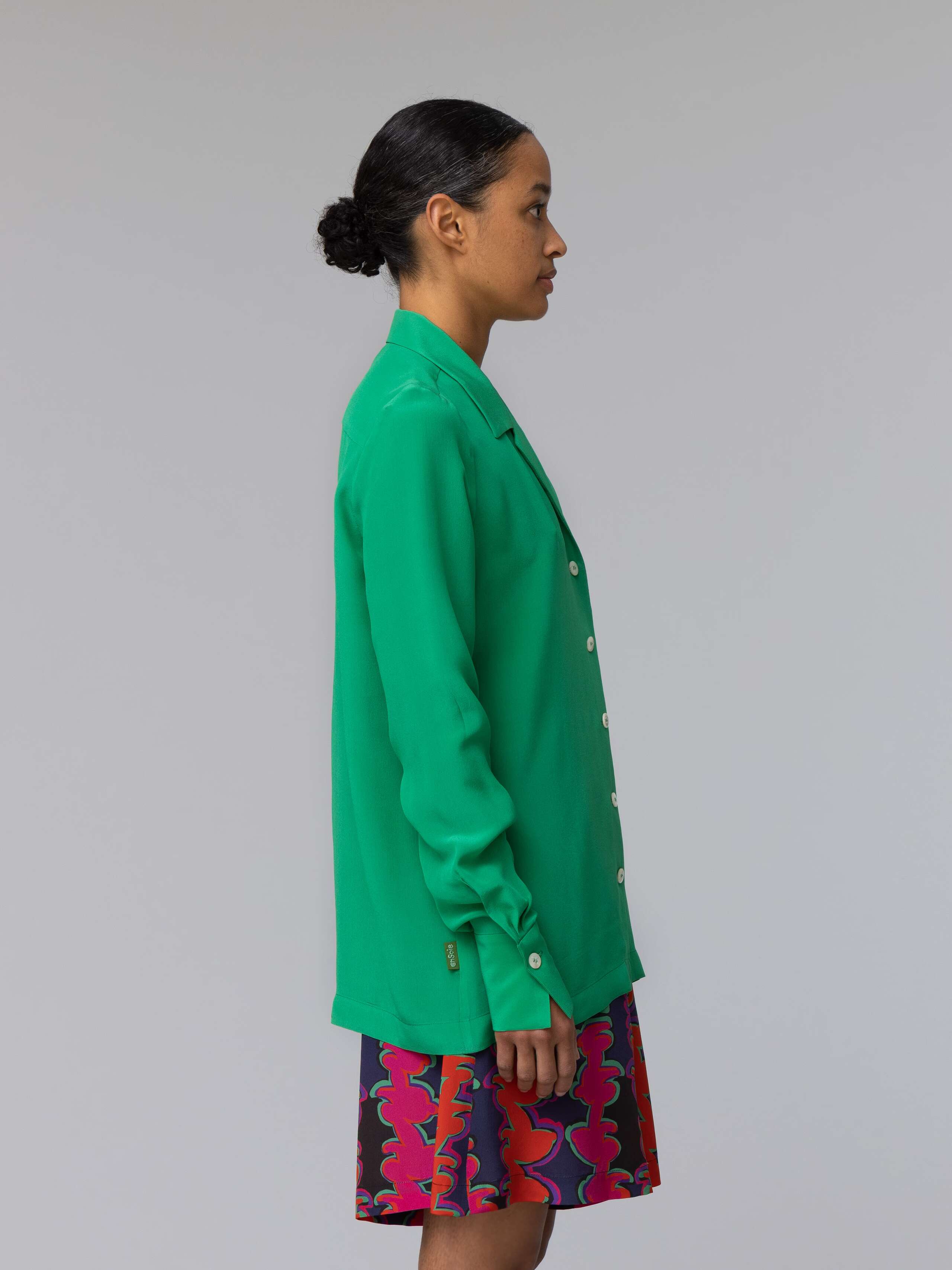 Model wears a bright green silk blouse 