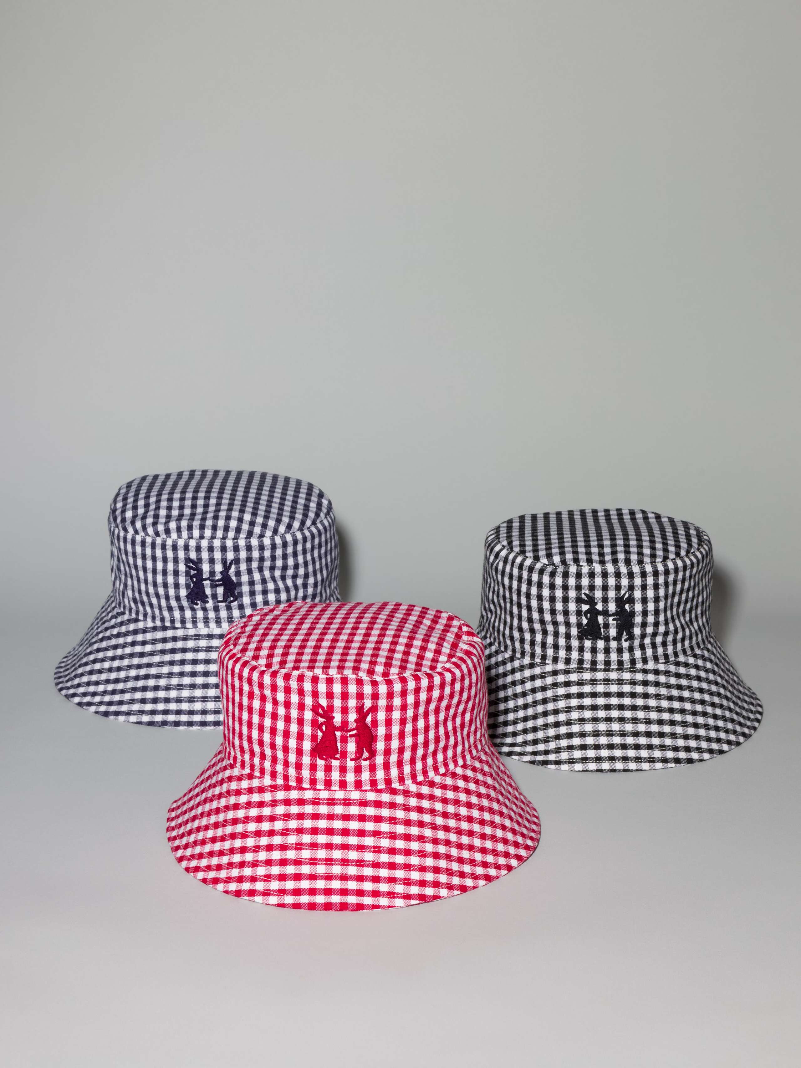 Picture of three bucket hats made of cotton featuring a beautiful vichy check pattern and rabbit embroidery