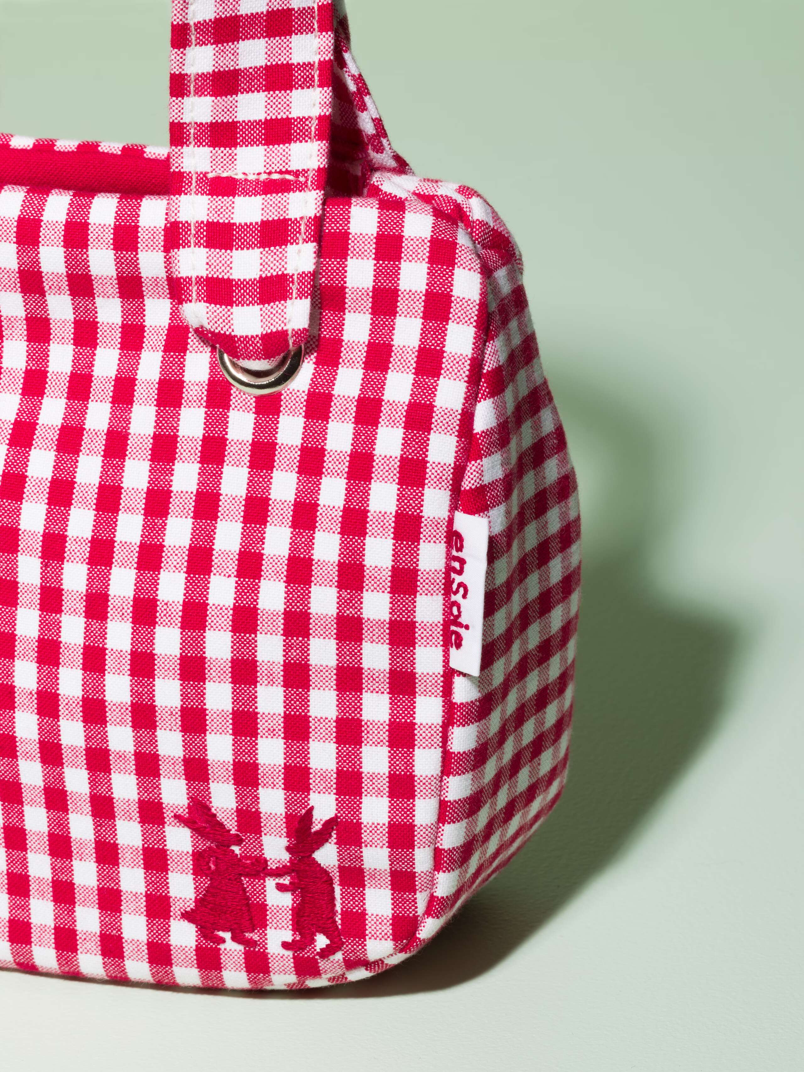 Detail of a cute small bag made of cotton featuring a red vichy check pattern