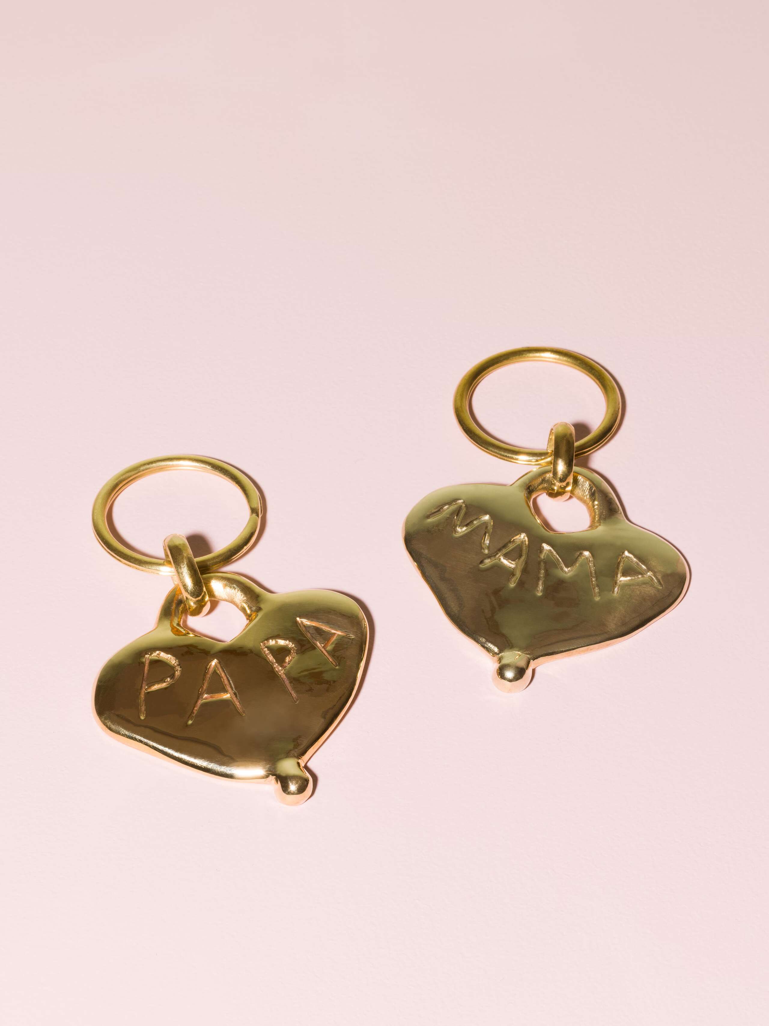 Two beautiful heart shaped brass keychains with MAMA and PAPA engravery 
