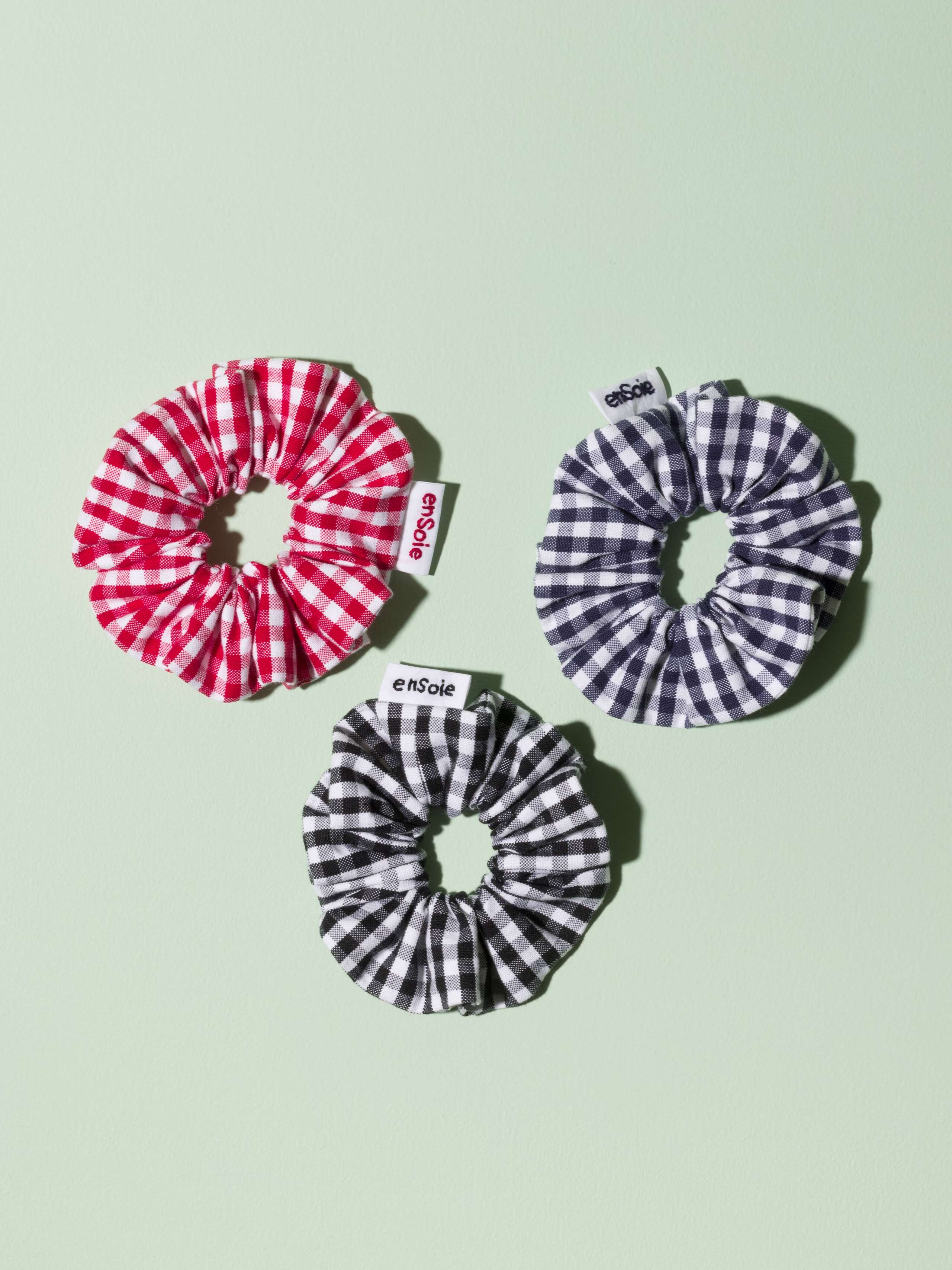 Three cute scrunchies made of cotton featuring a cute vichy check pattern