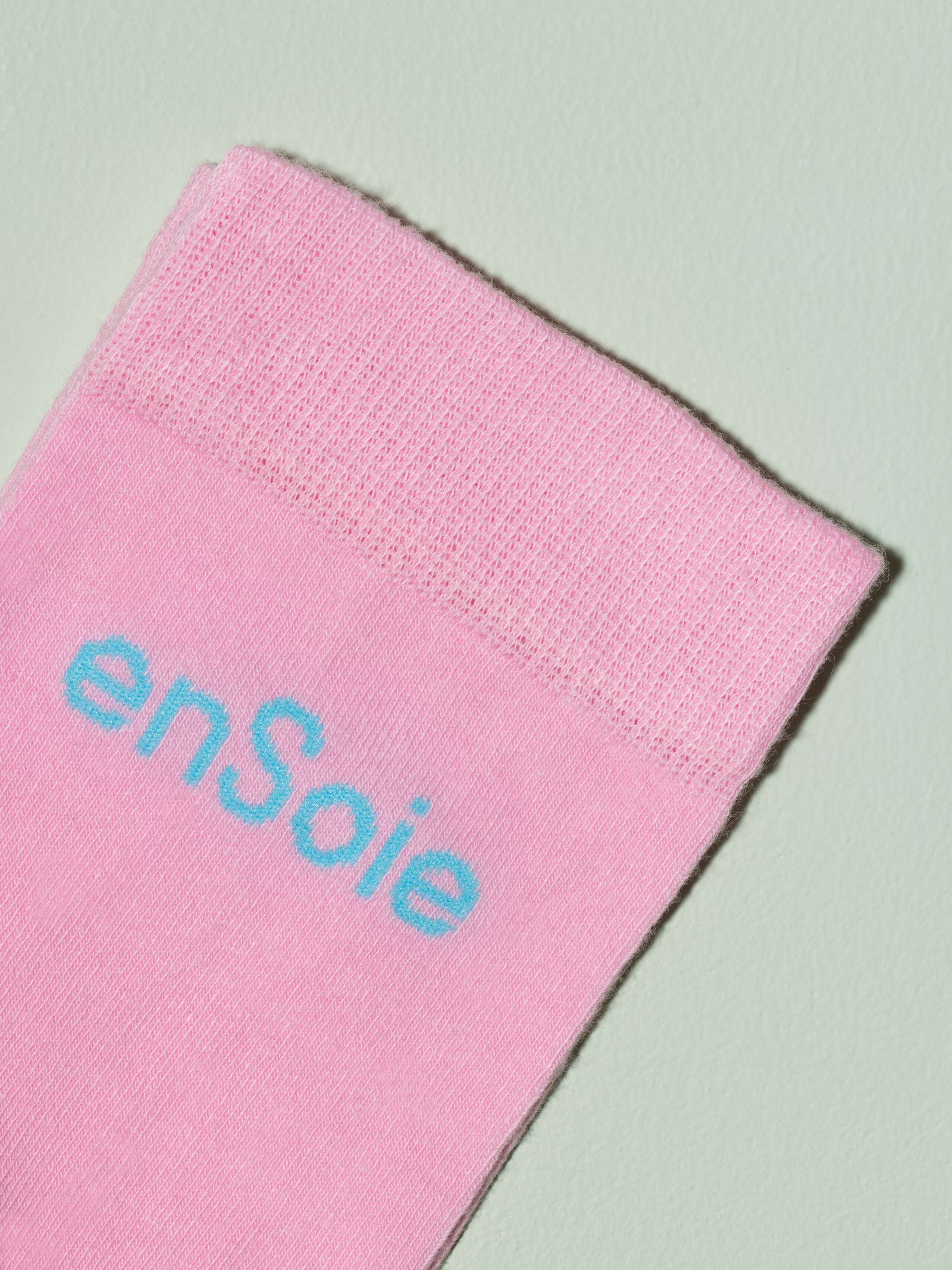 Picture of a pink sock with blue embroidery