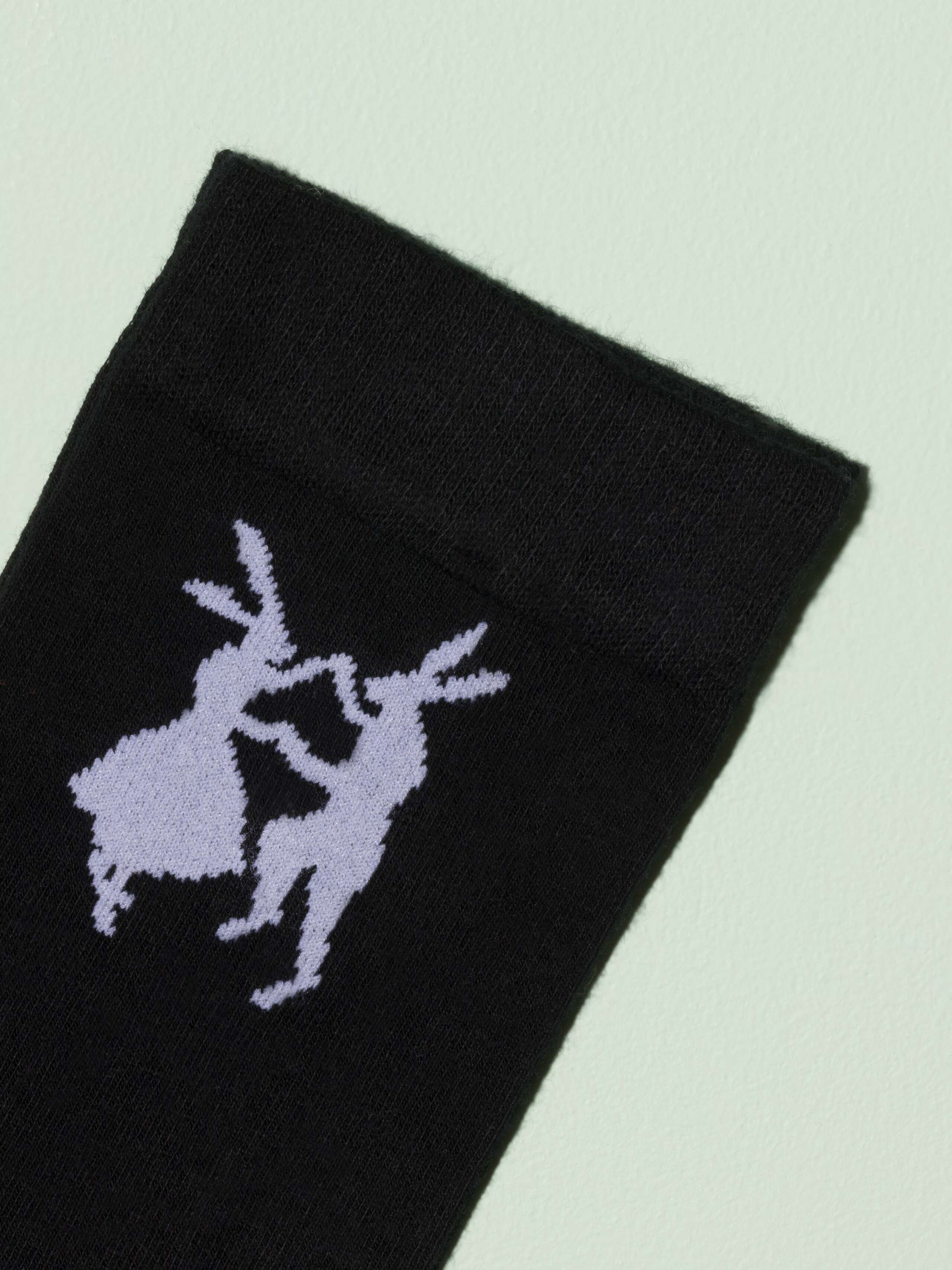 Picture of a black sock with white rabbit