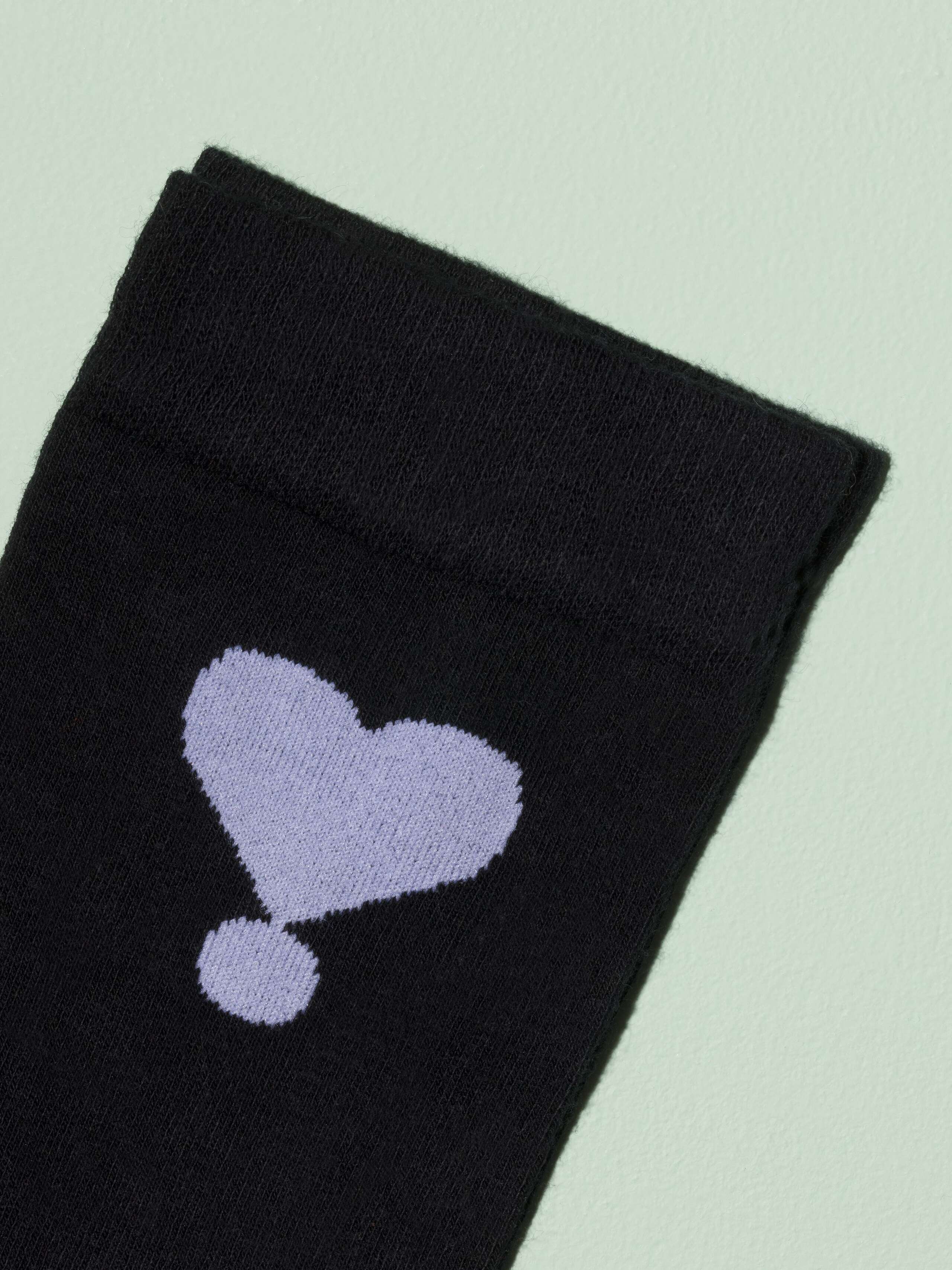 Picture of a black sock with white heart