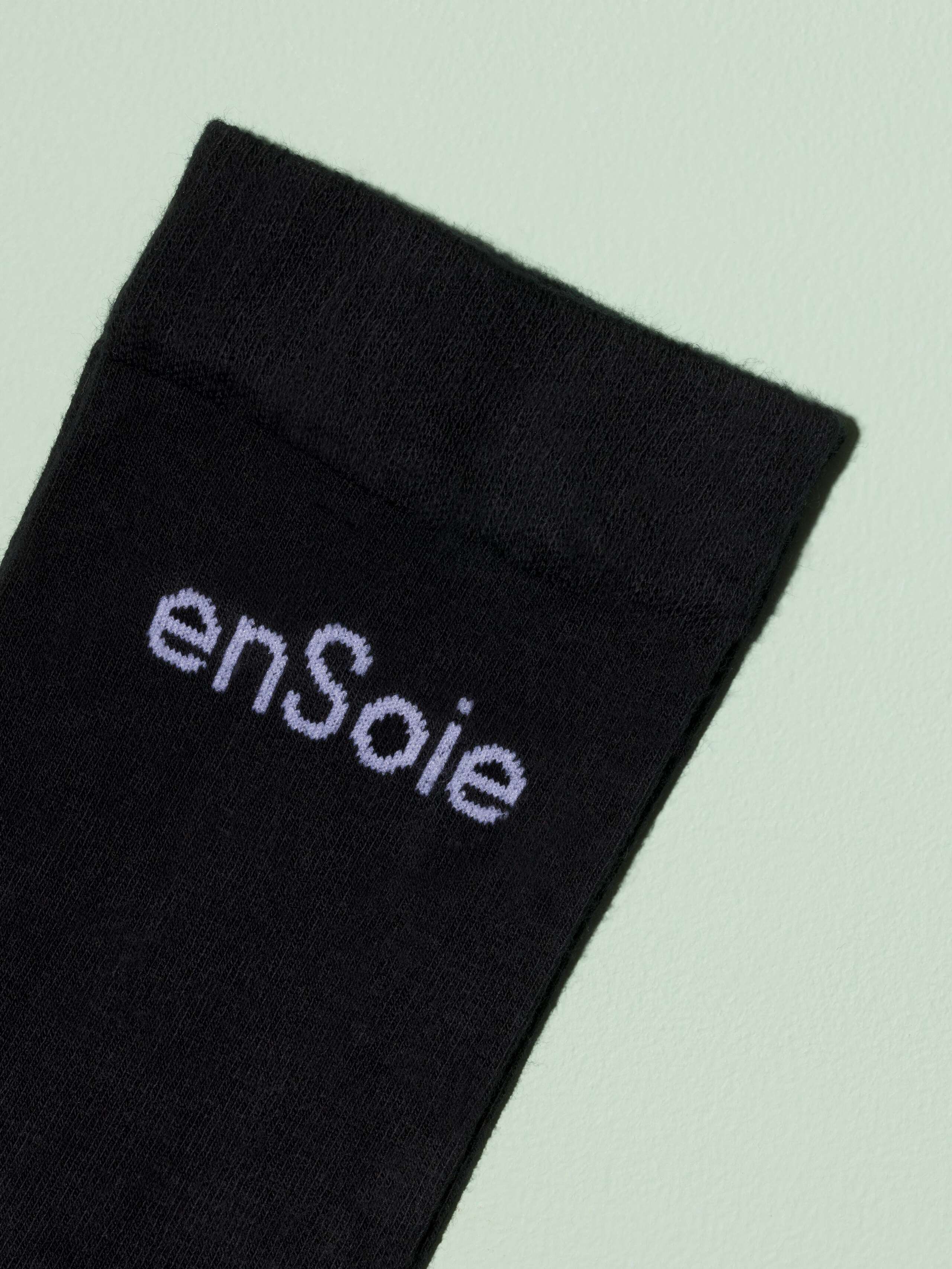 Picture of a black sock with white enSoie logo