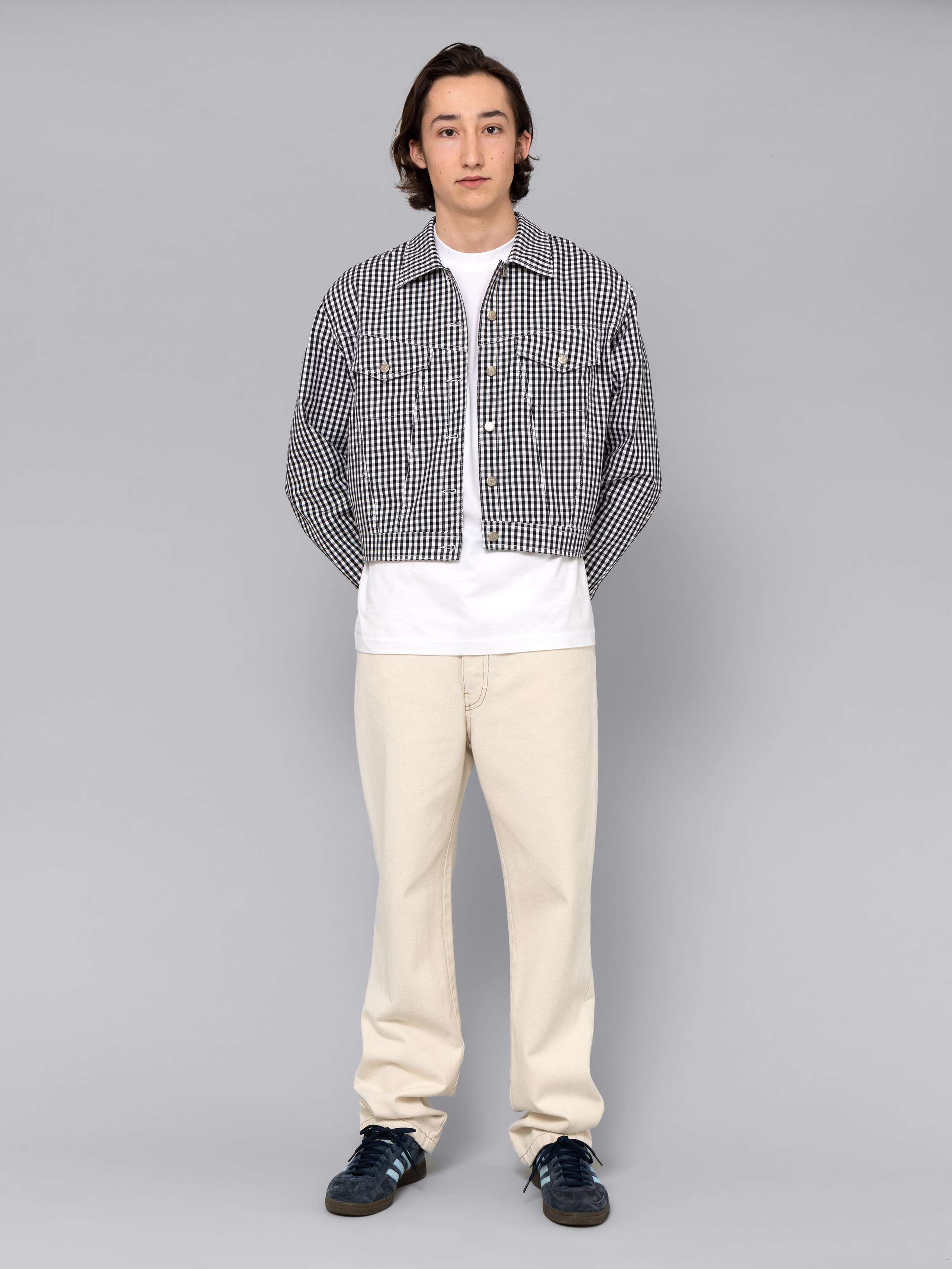 Male model is wearing a beautiful denim jacket featuring a beautiful black vichy check pattern