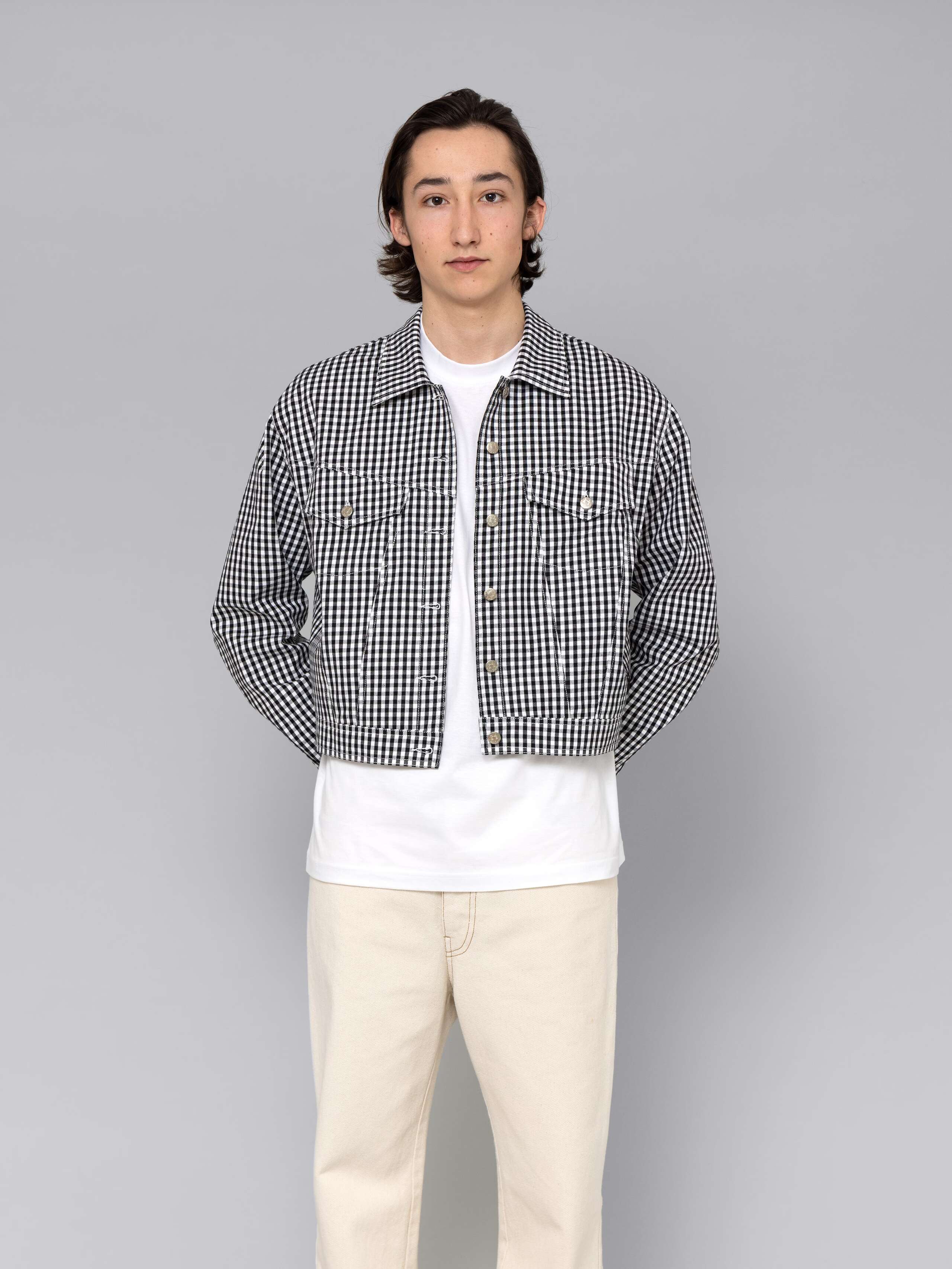 Male model is wearing a beautiful denim jacket featuring a beautiful black vichy check pattern