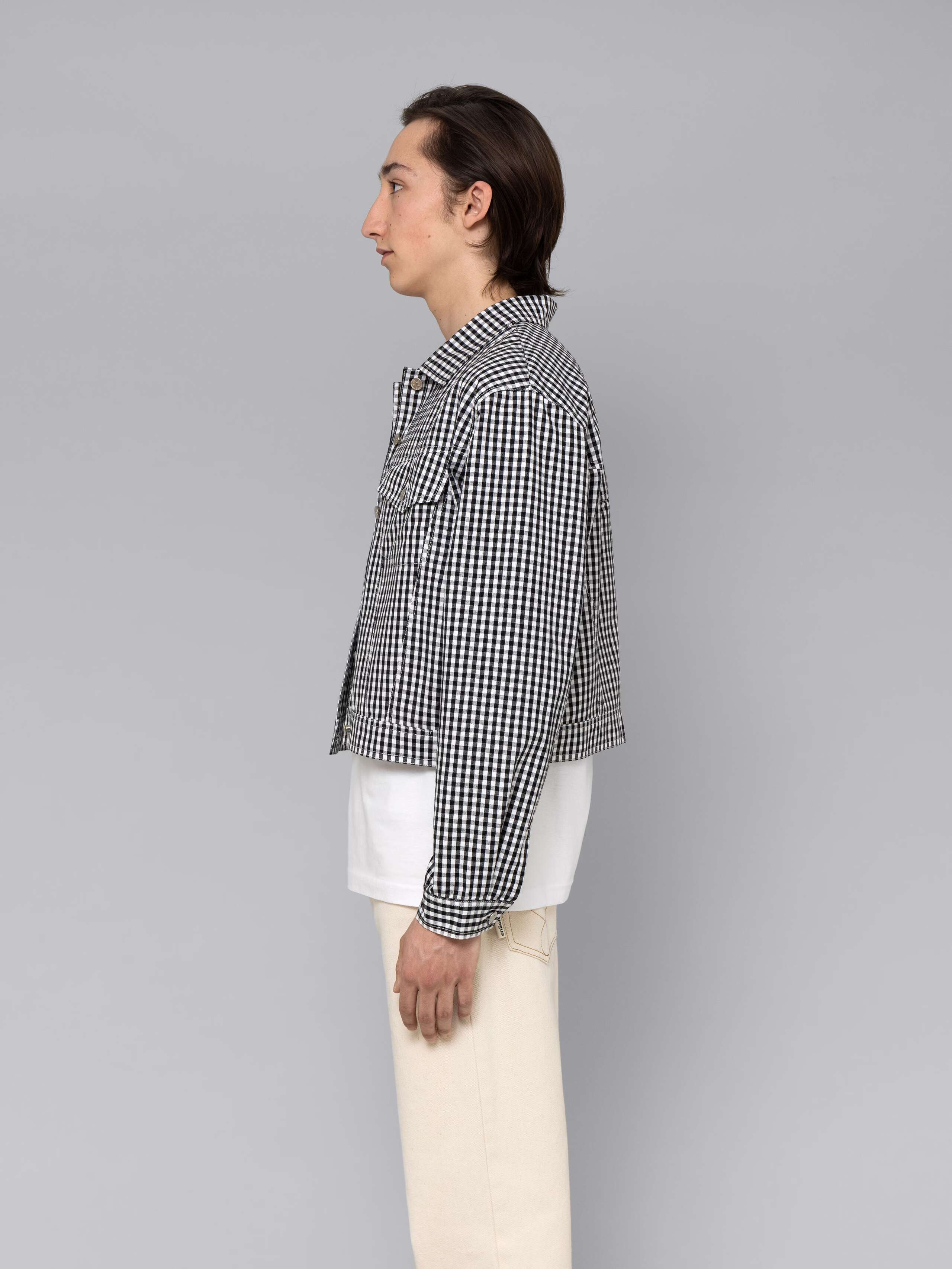 Male model is wearing a beautiful denim jacket featuring a beautiful black vichy check pattern