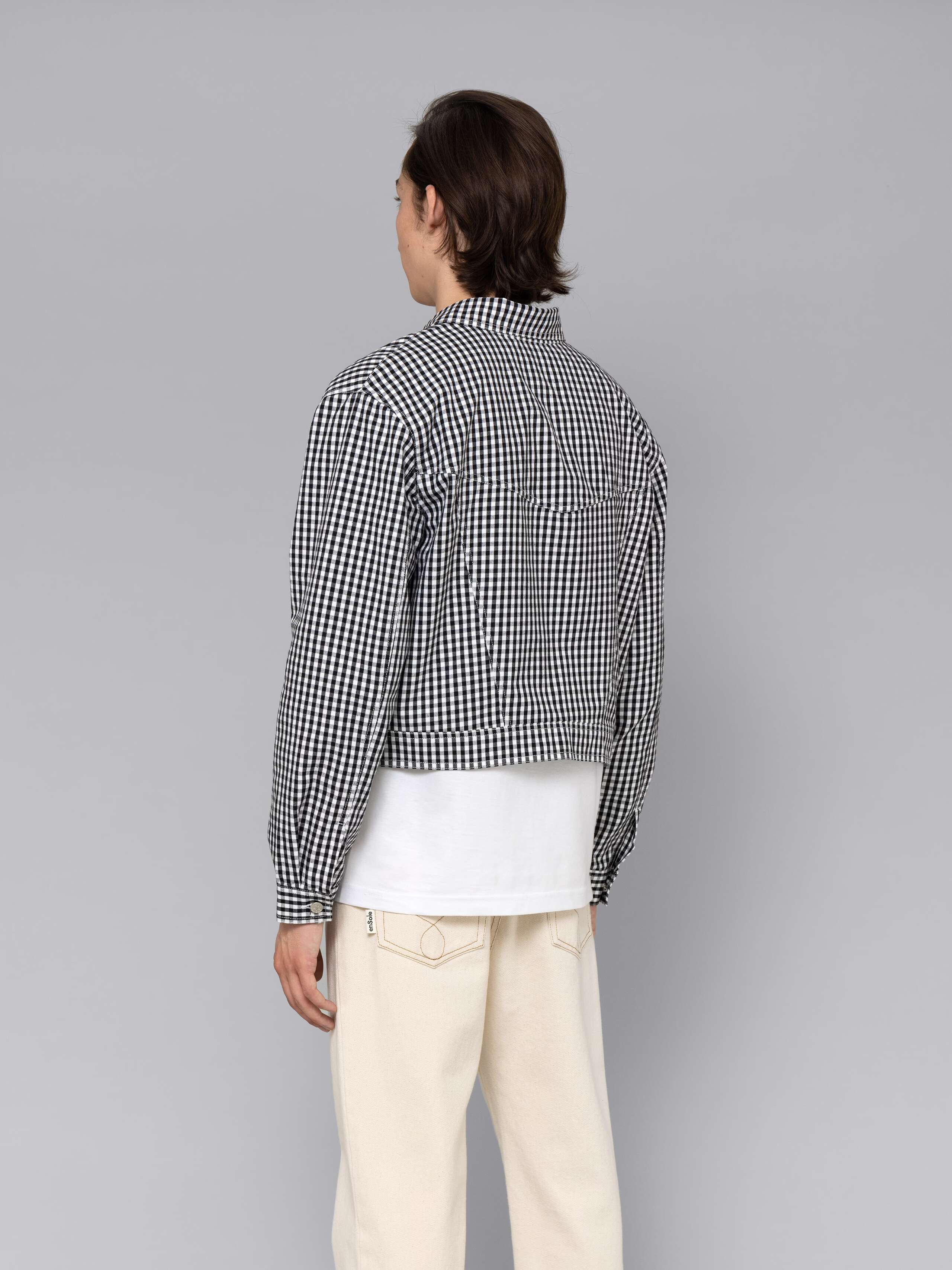 Male model is wearing a beautiful denim jacket featuring a beautiful black vichy check pattern