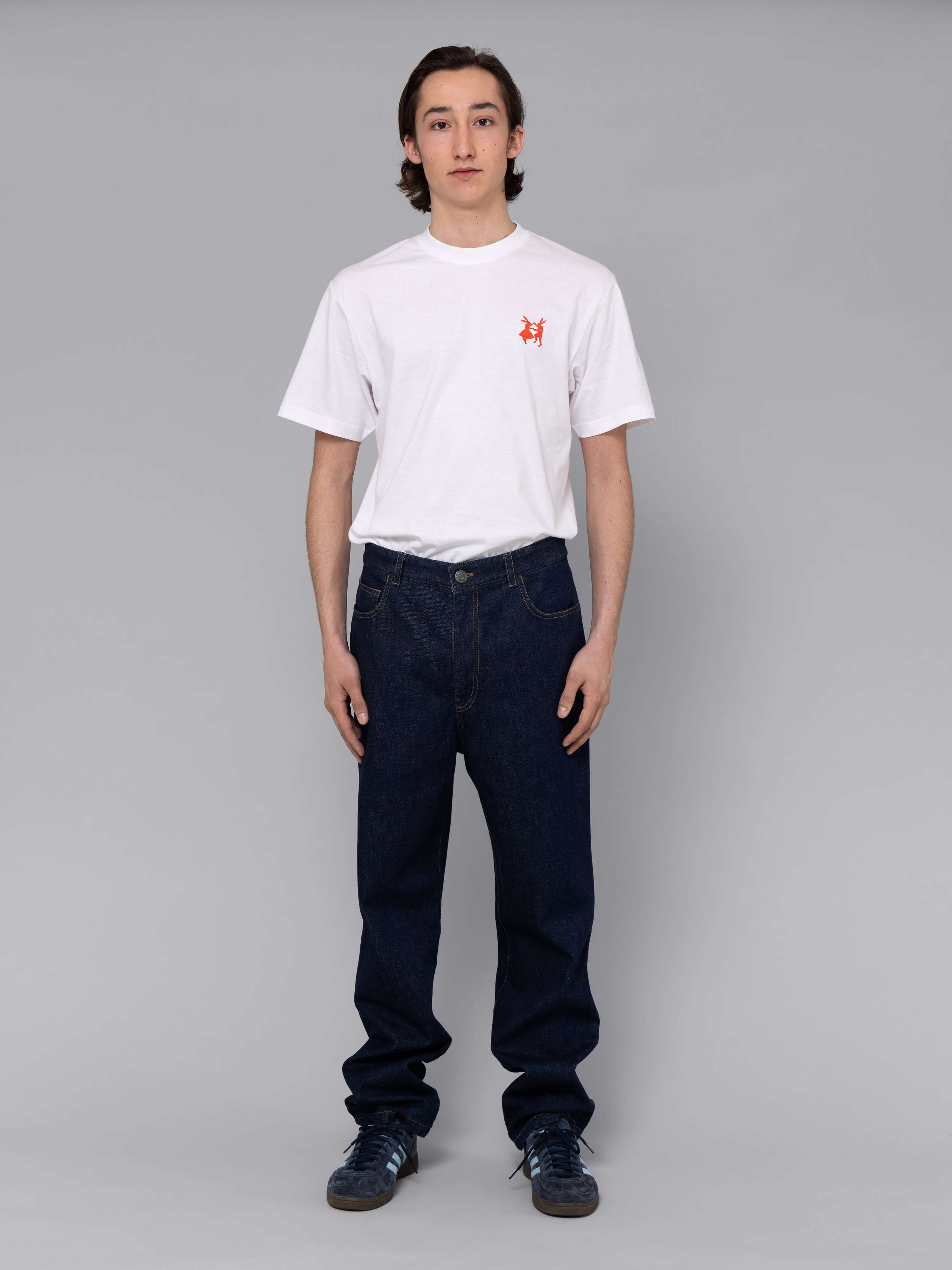 Male model is wearing a combination of a classic jeans and a white t-shirt