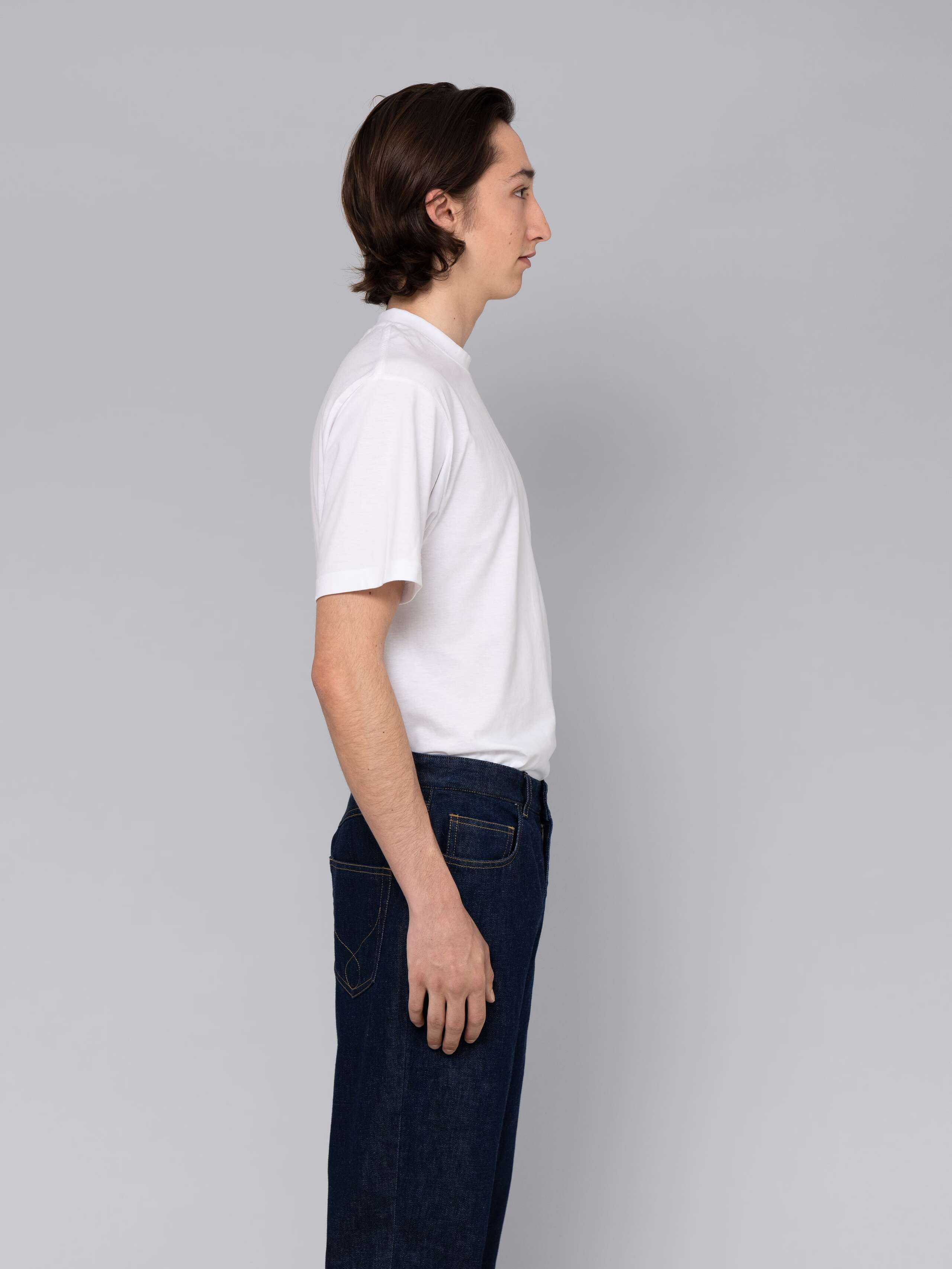 Male model is wearing a combination of a classic jeans and a white t-shirt