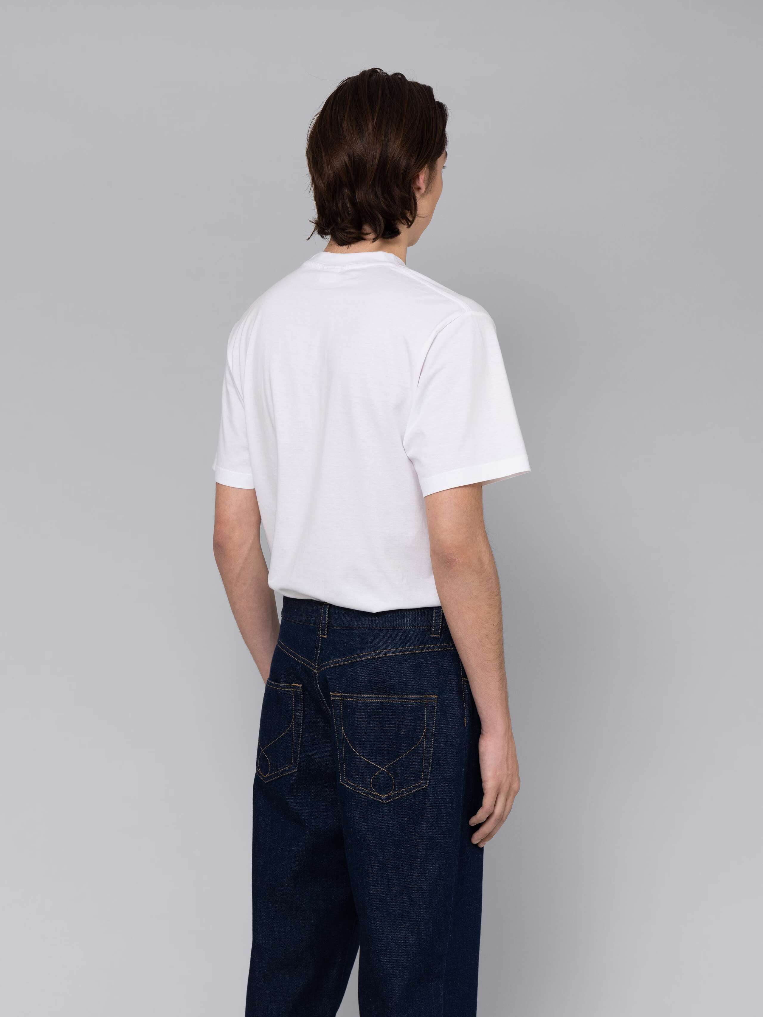 Male model is wearing a combination of a classic jeans and a white t-shirt