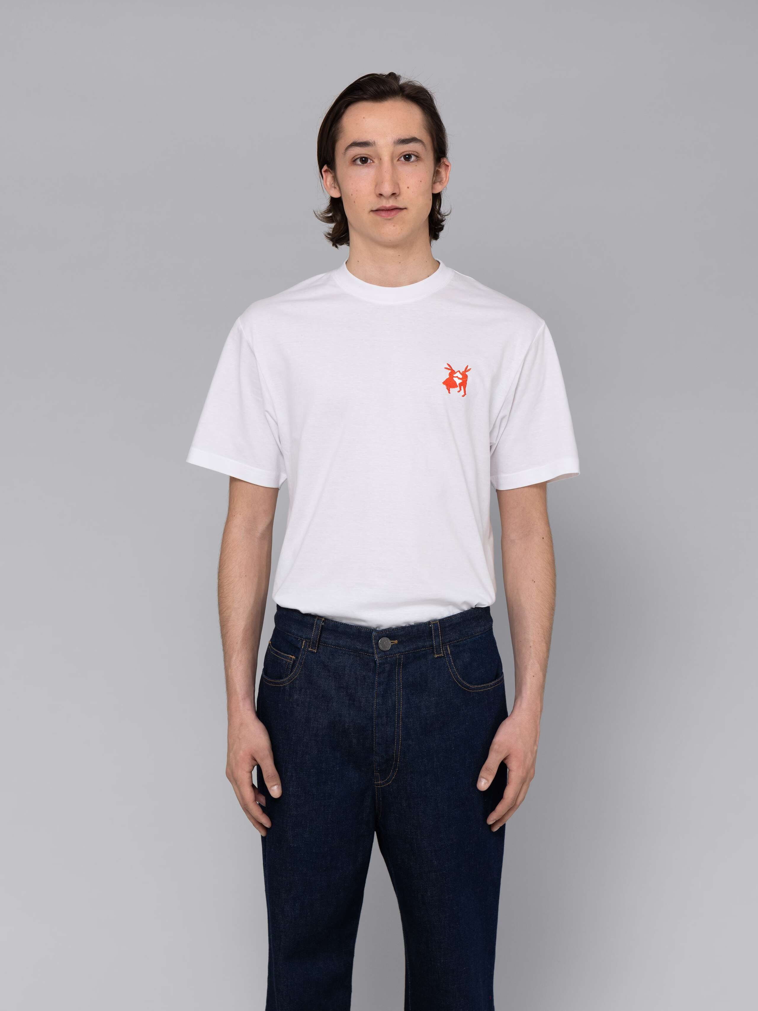 Male model is wearing a combination of a classic jeans and a white t-shirt